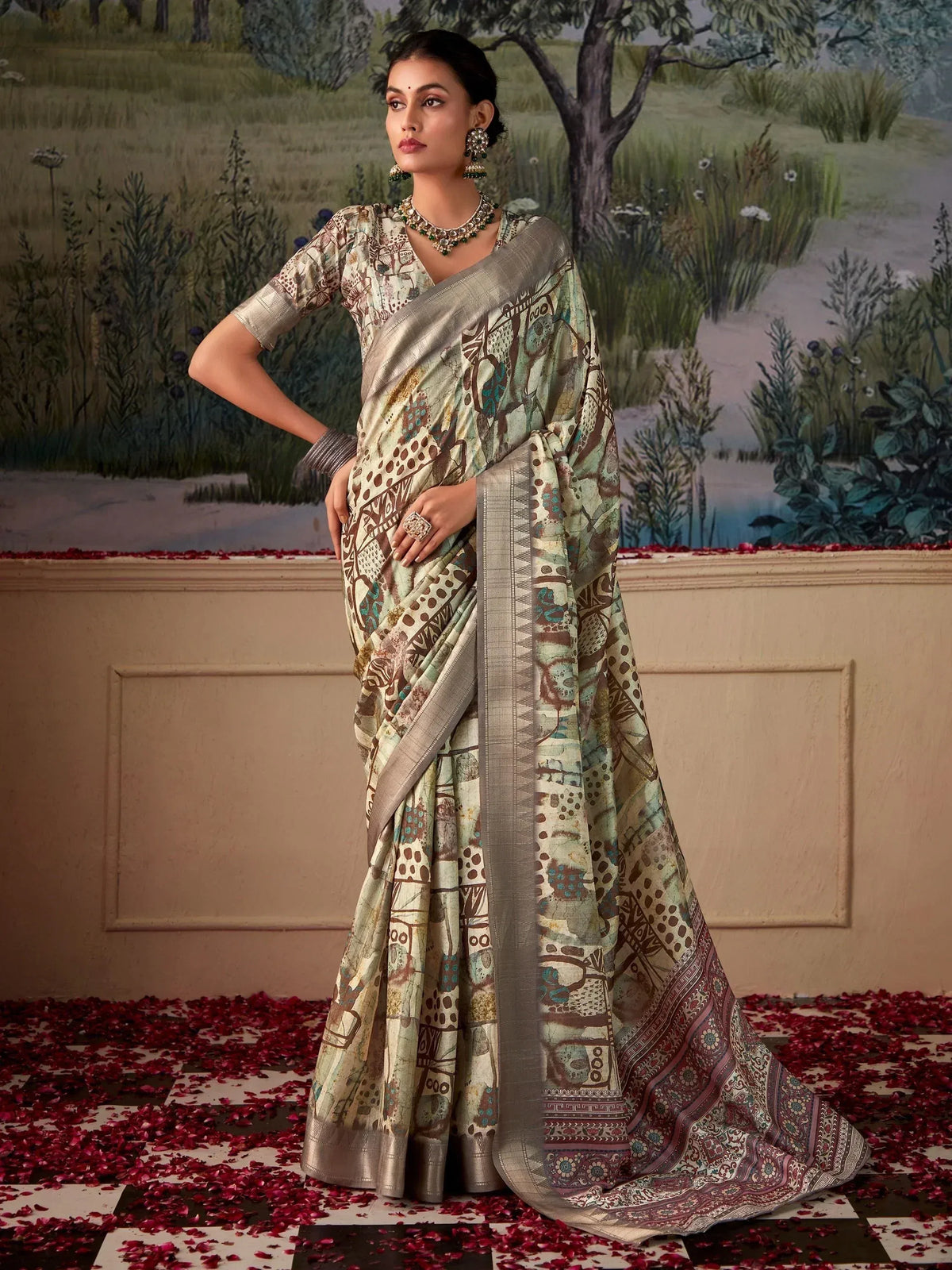 Woman in elegant printed saree with silver border, traditional Indian ethnic wear, floral backdrop