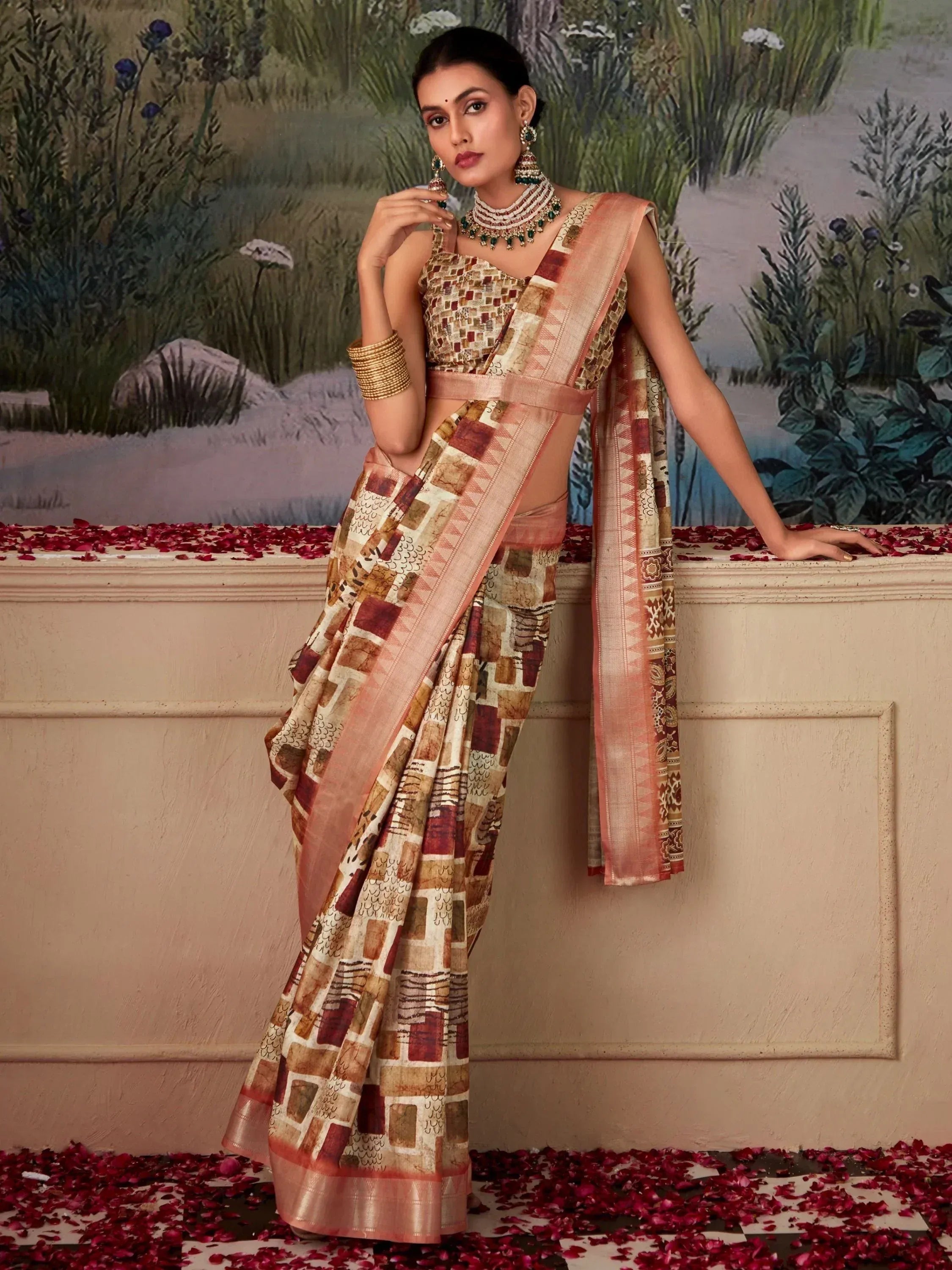 Woman in elegant printed saree with geometric pattern, traditional jewelry, and rose petals, ideal for ethnic occasions