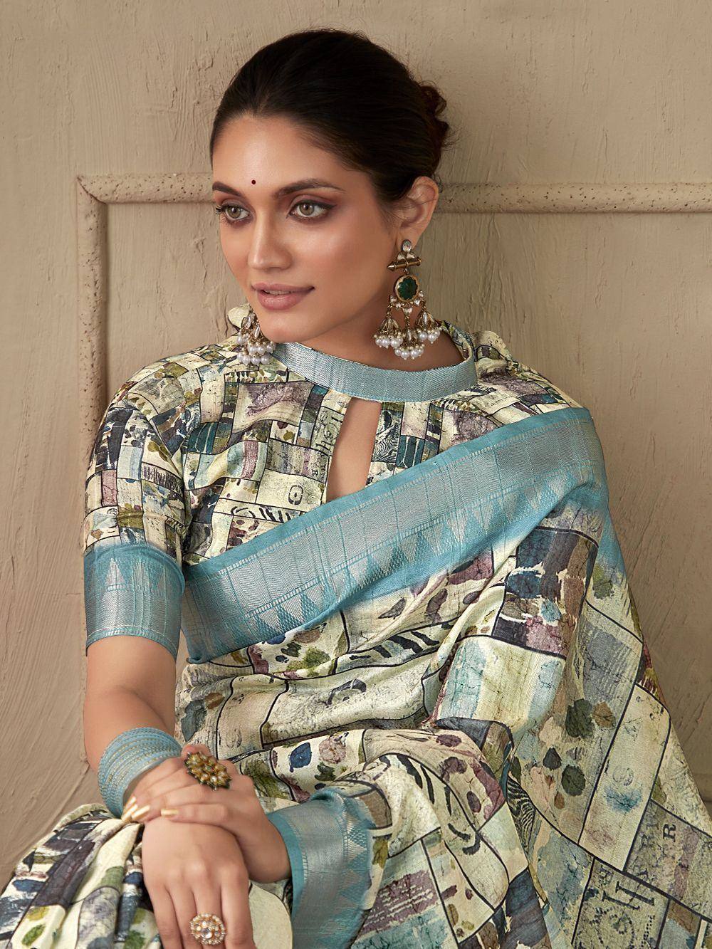 Woman in printed saree with blue border, ethnic Indian wear, designer blouse, traditional jewelry