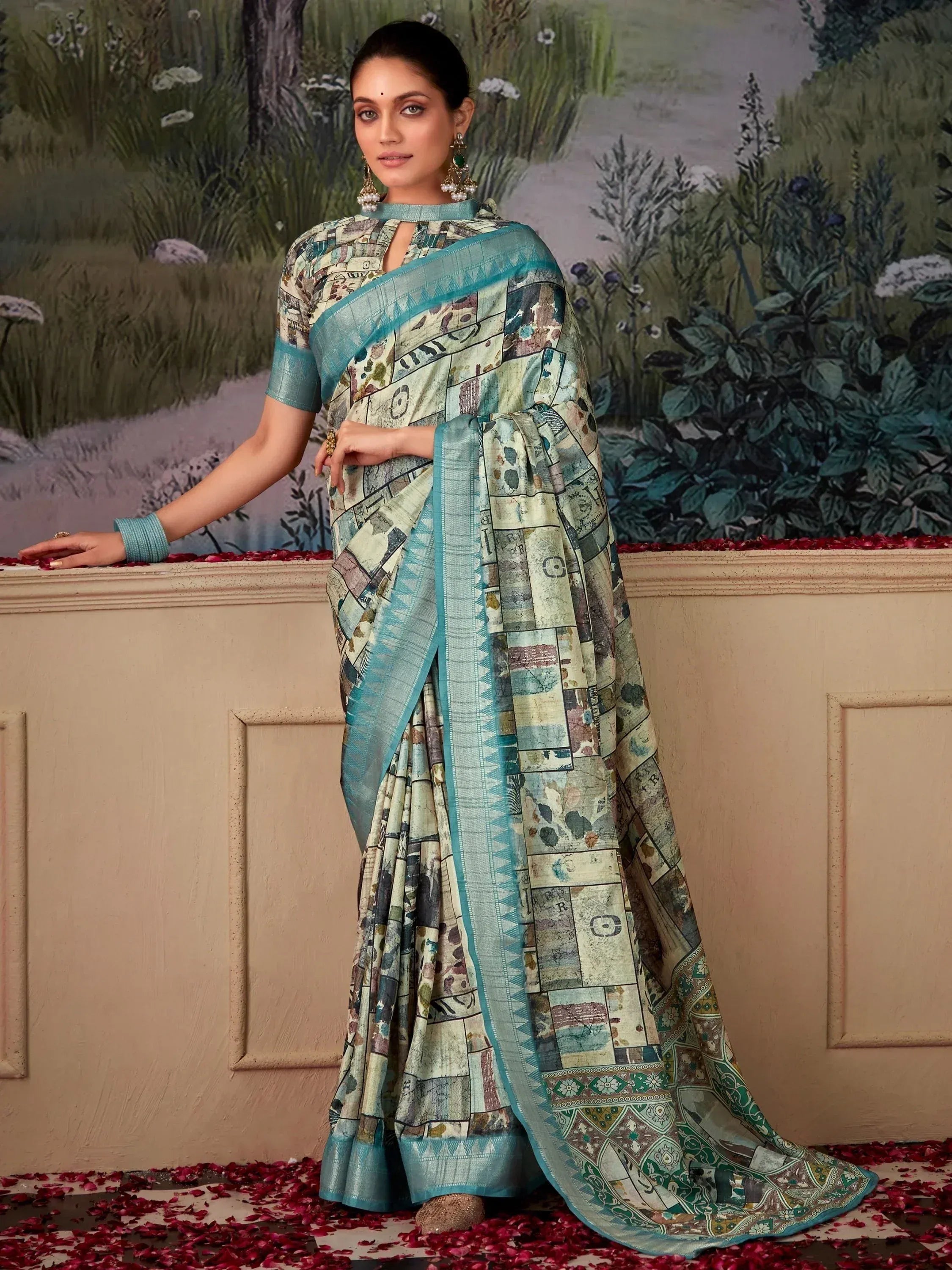 Woman in printed ethnic saree with teal border, styled for Indian occasions, floral backdrop