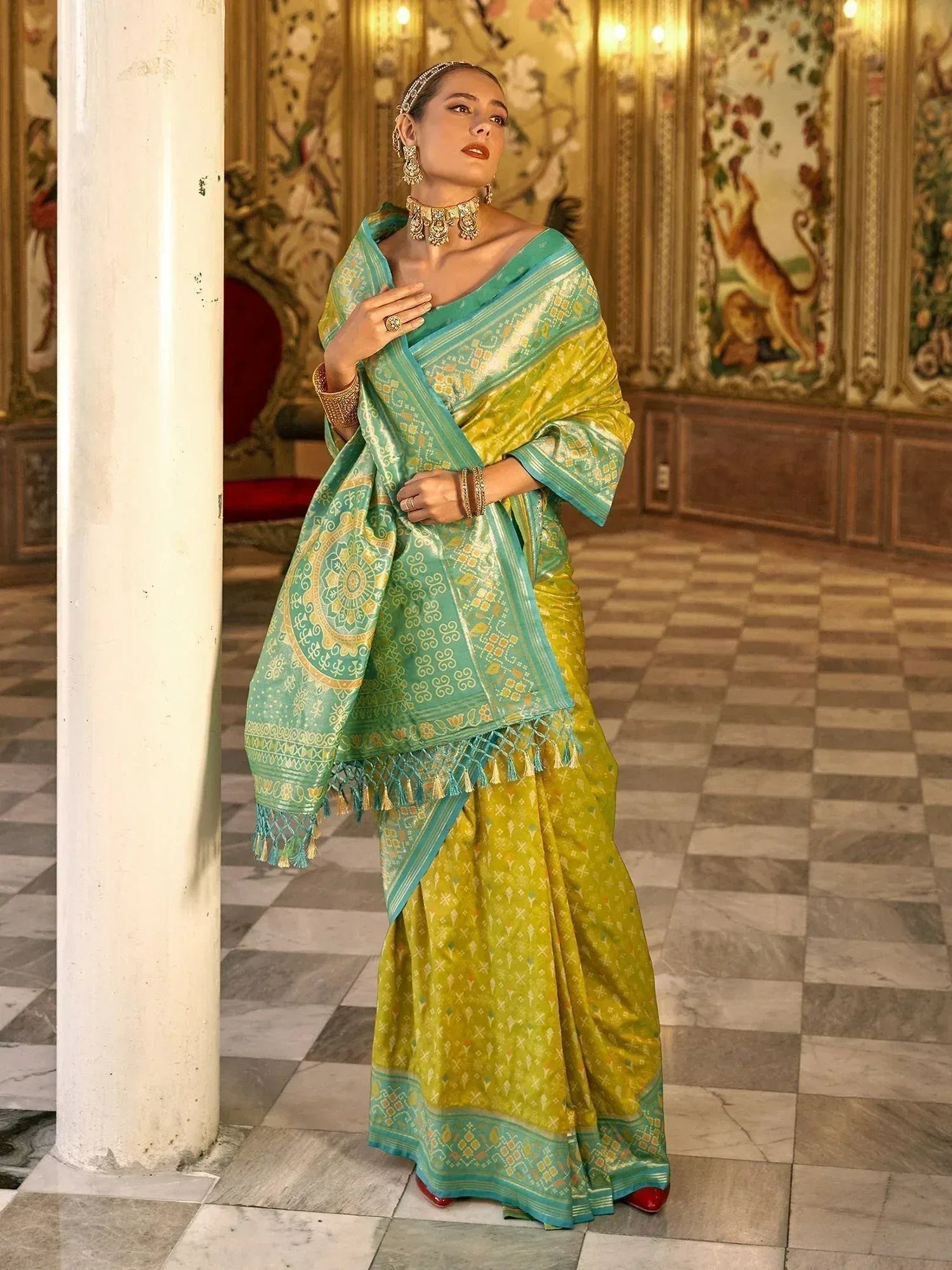 Elegant green and yellow designer saree with intricate patterns and tassels, perfect for Indian ethnic occasions