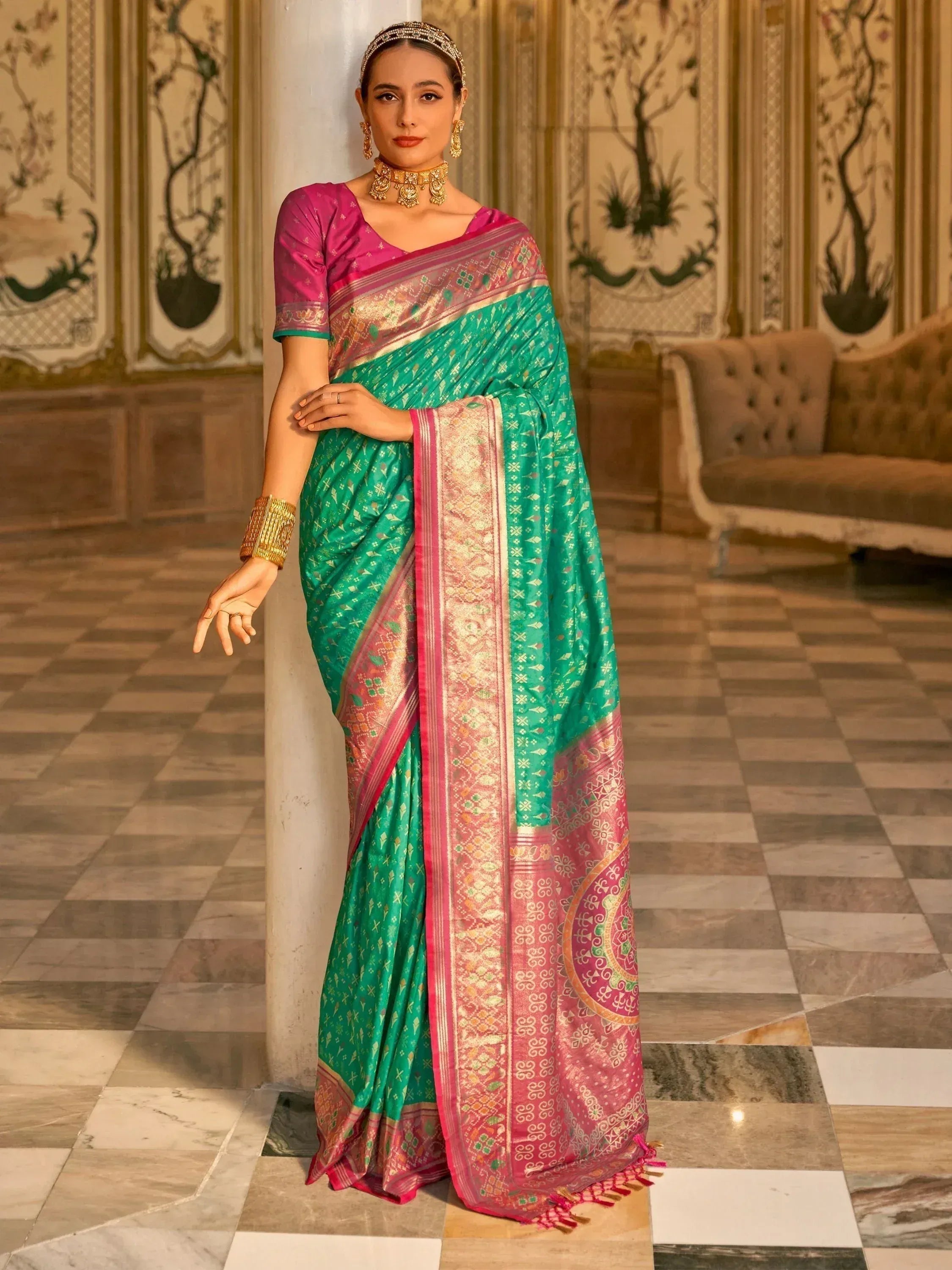 Elegant green and pink designer saree with intricate gold patterns, perfect for Indian ethnic wear occasions.