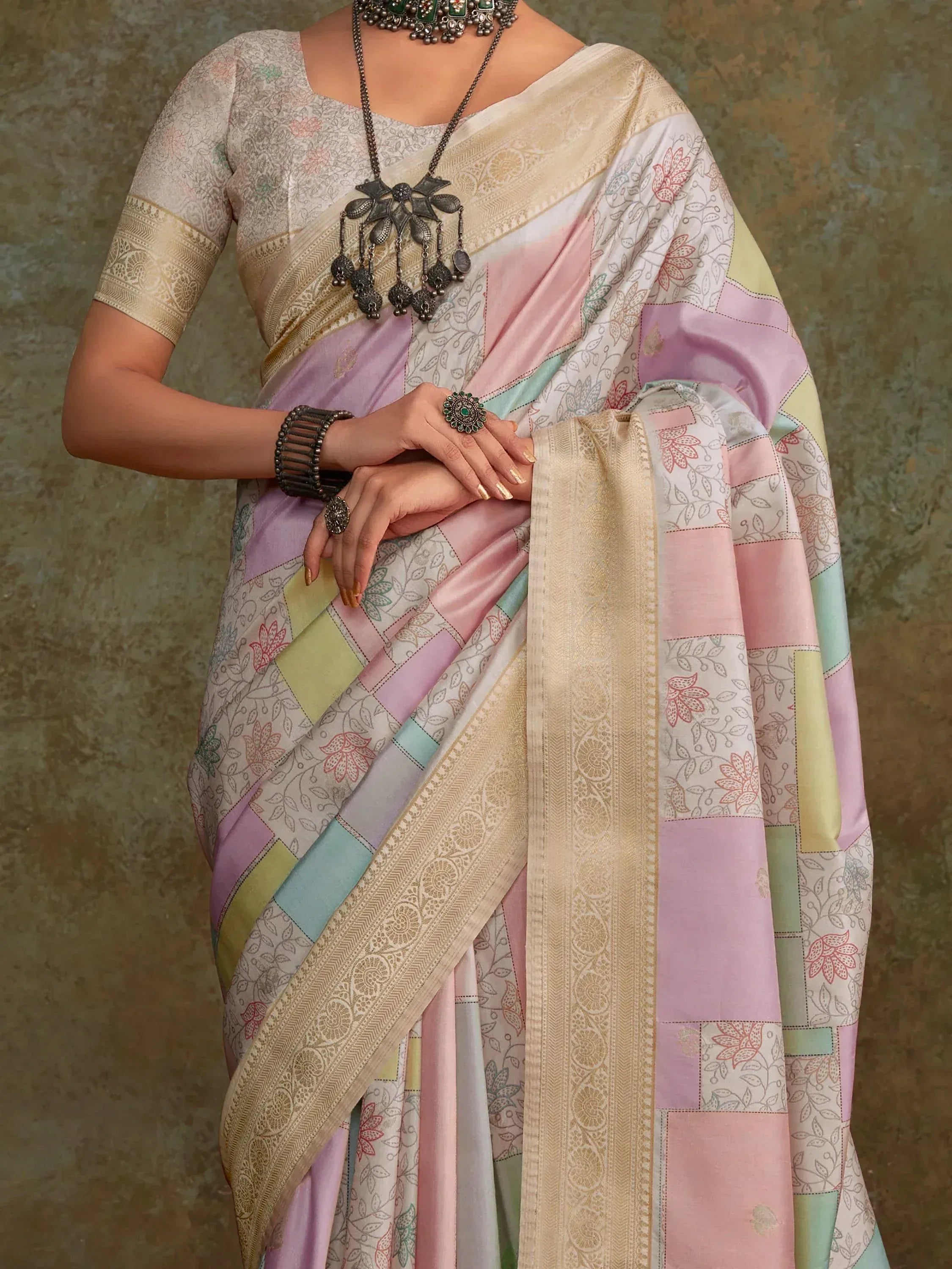 Pastel patchwork saree with floral print and gold border, styled with ethnic jewelry for Indian ethnic wear