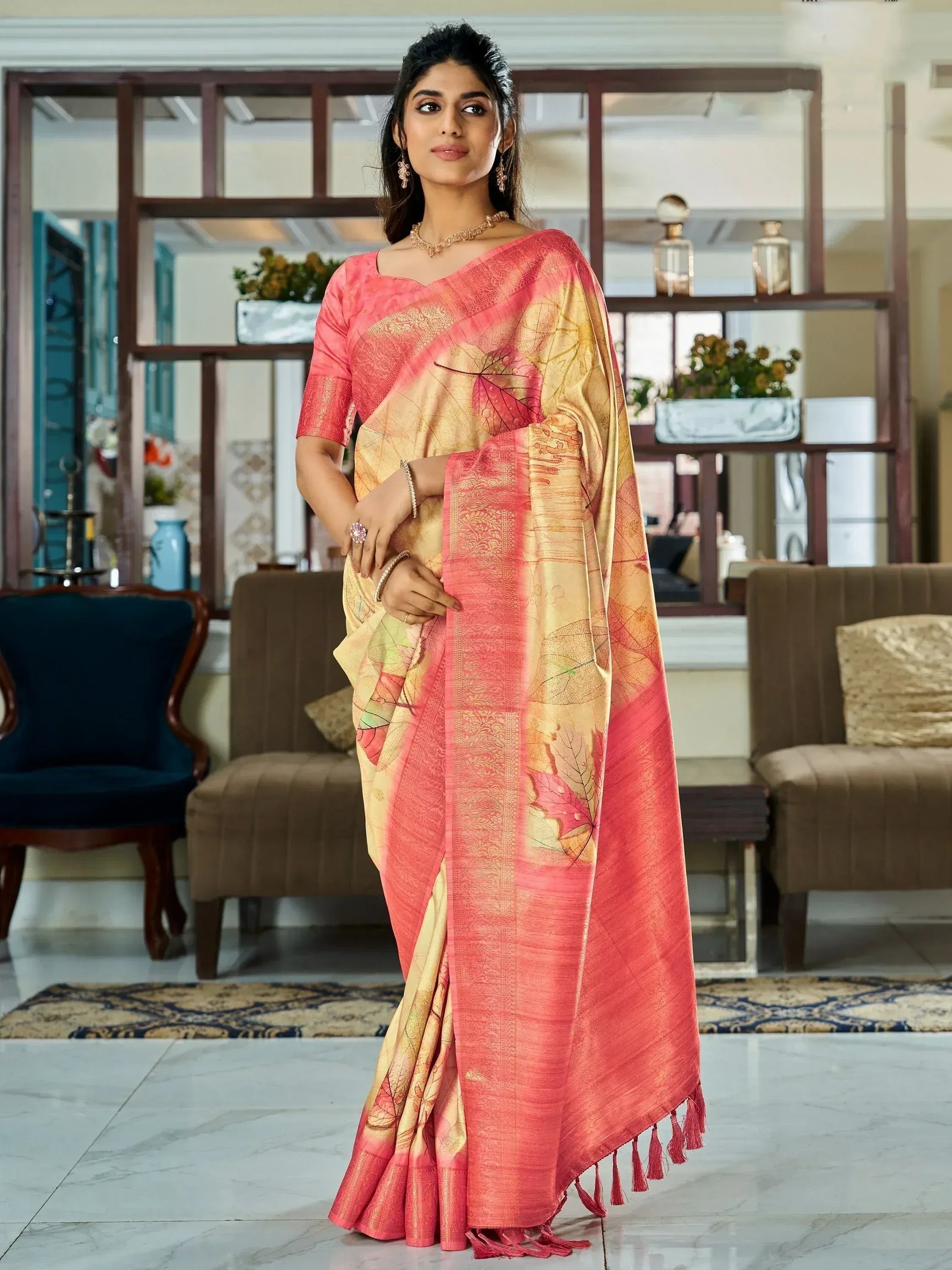 Elegant pink and gold saree with leaf prints, perfect for ethnic occasions
