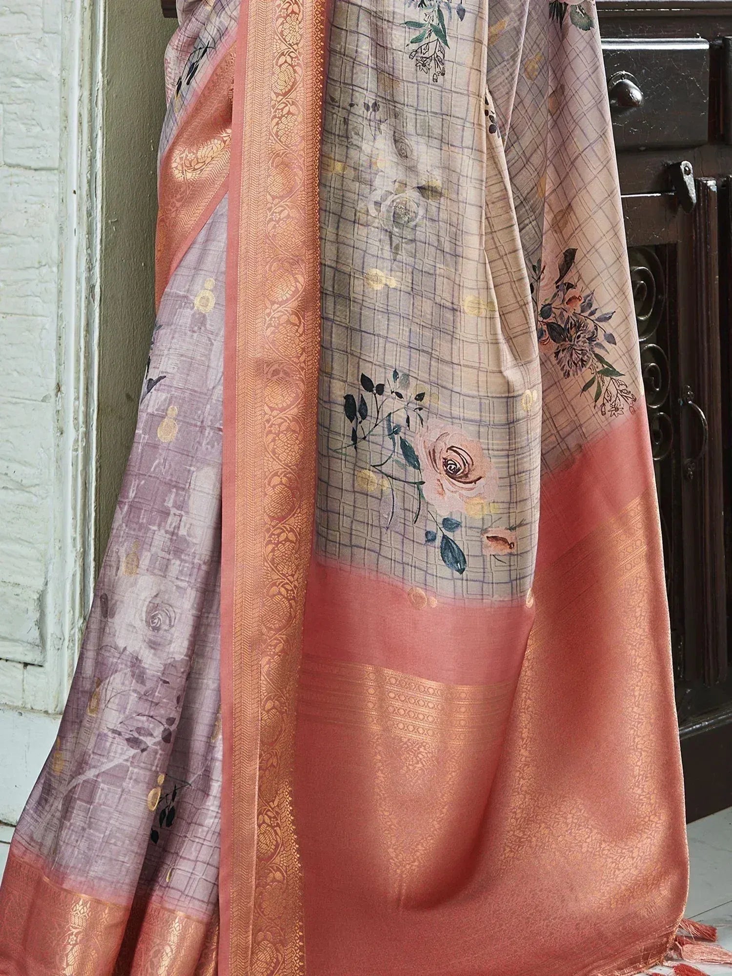 Elegant floral saree with golden border and soft pastel hues, perfect for ethnic occasions.