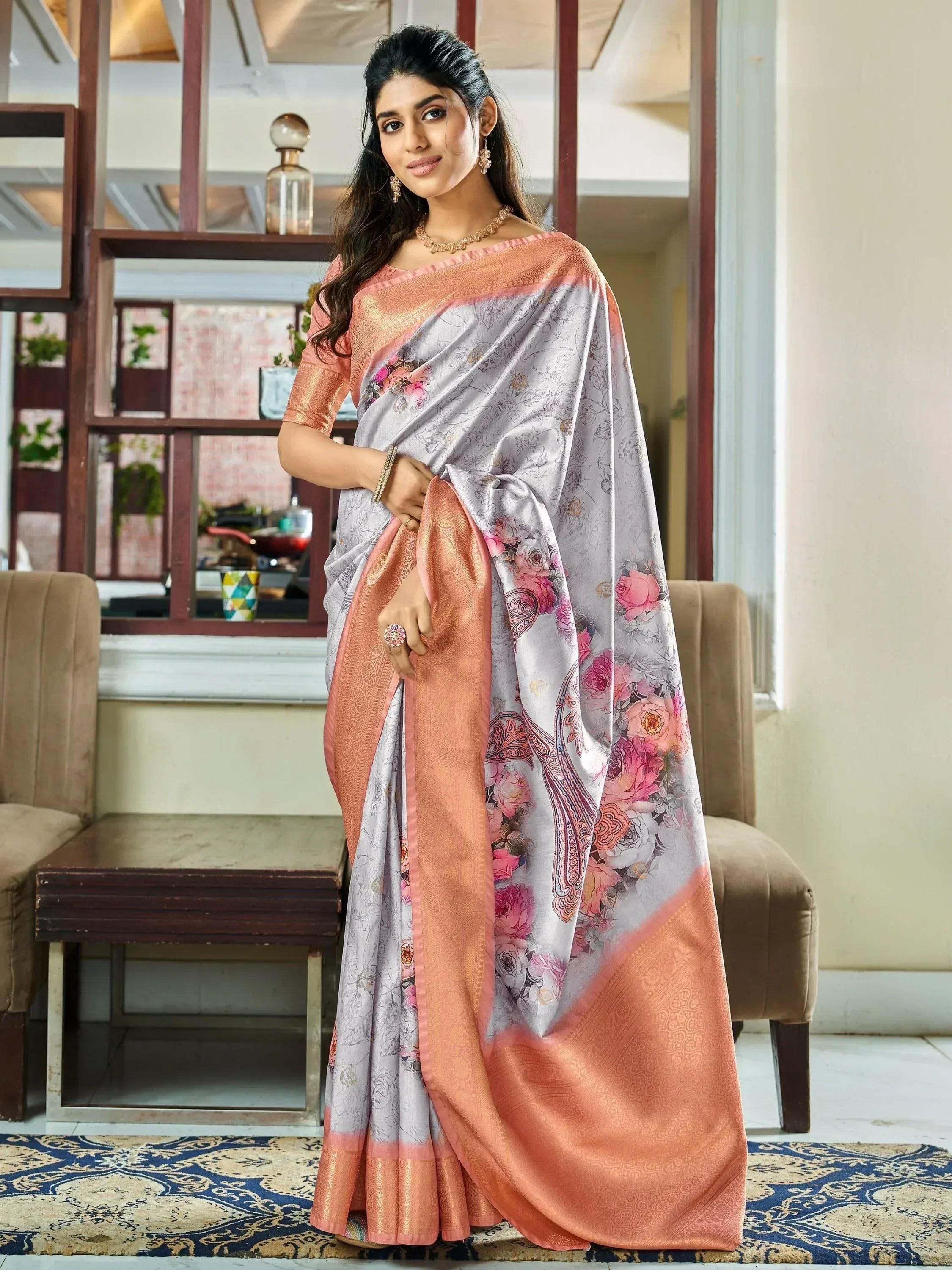 Elegant grey saree with pink floral print and peach border, perfect for Indian ethnic wear occasions.