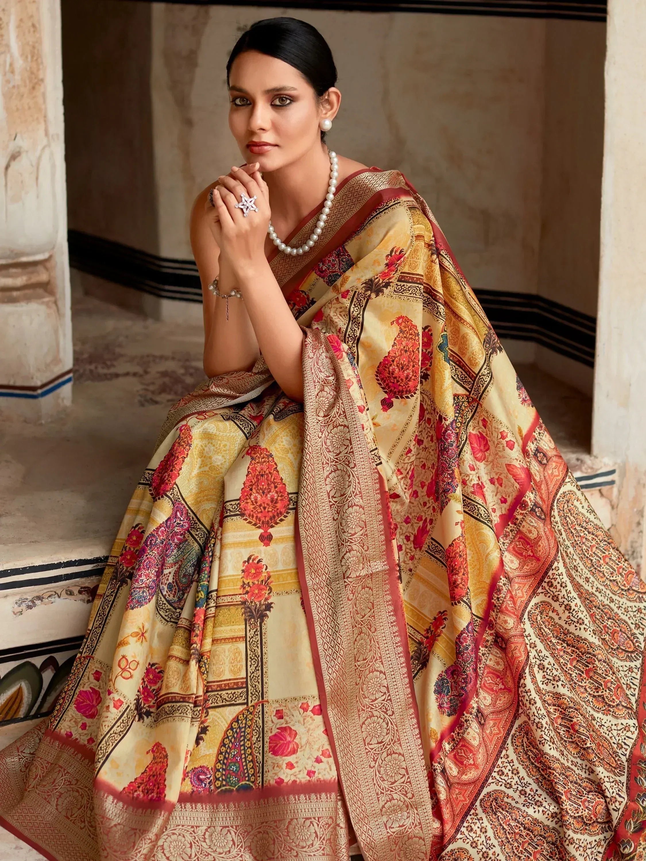 Elegant woman in designer saree with floral and paisley patterns, perfect for Indian ethnic wear.