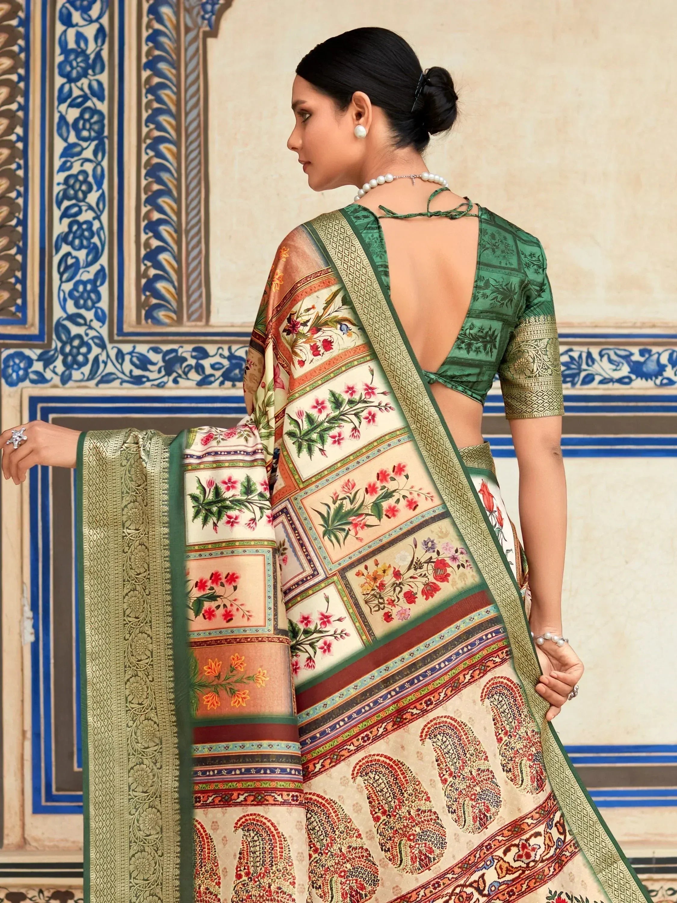 Woman in floral print saree with green blouse, ethnic Indian wear, paisley border, traditional design