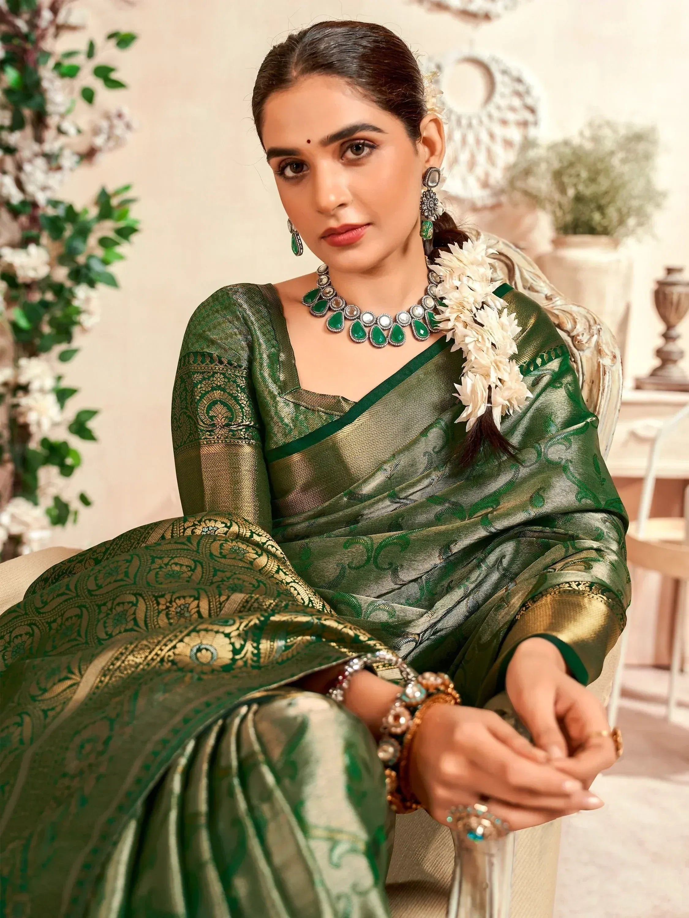 Elegant green and gold designer saree with intricate patterns, perfect for Indian ethnic wear occasions.