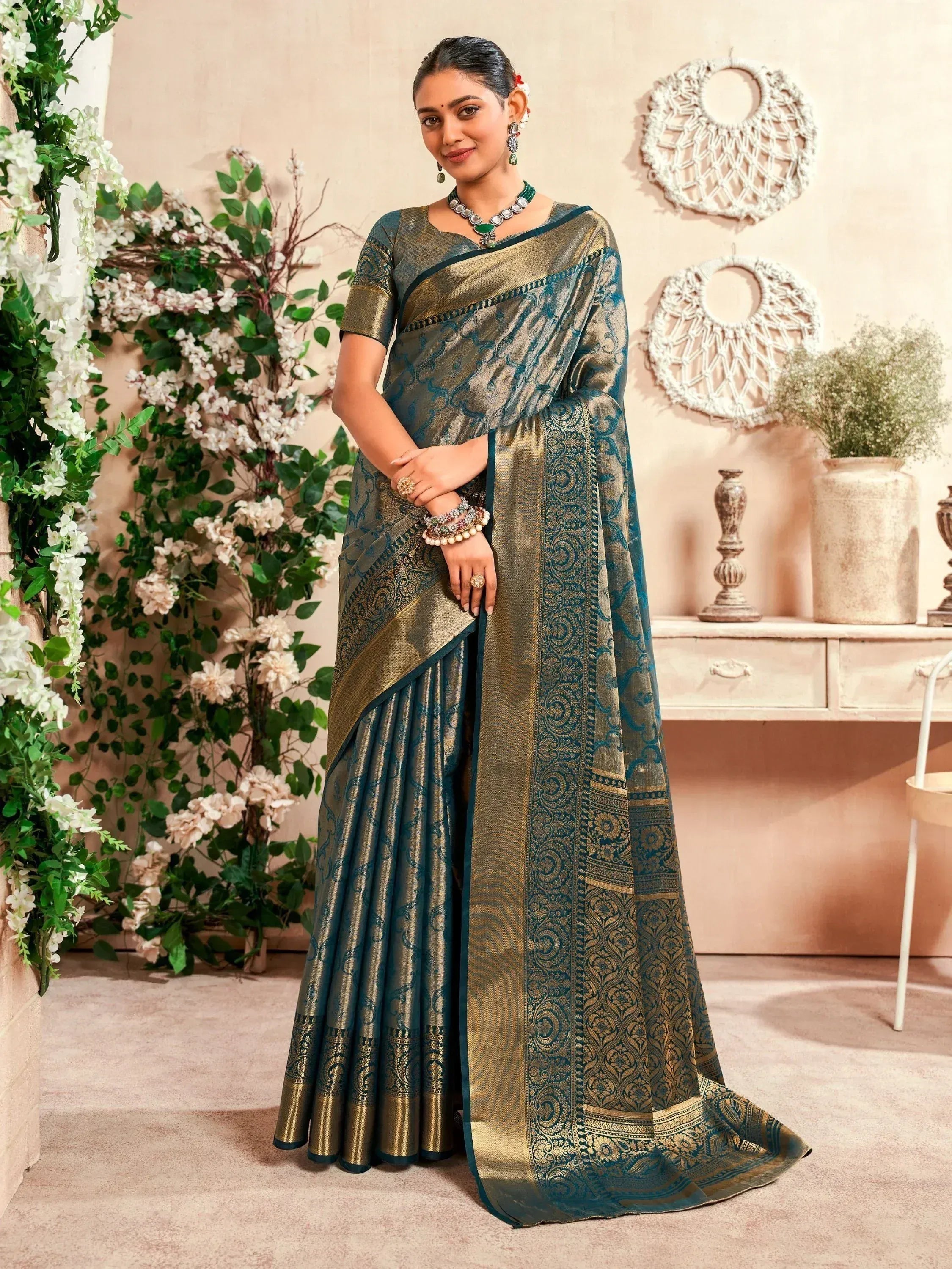 Elegant teal and gold designer saree with intricate brocade work, perfect for Indian ethnic wear occasions.