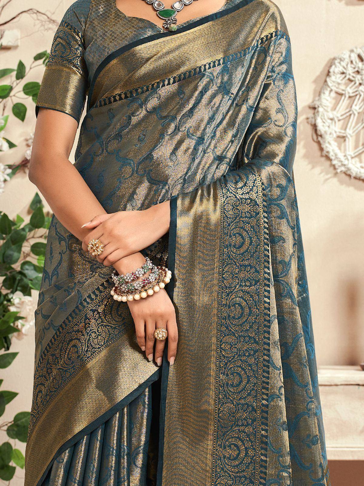 Elegant teal and gold designer saree with intricate paisley weave, perfect for Indian ethnic occasions.