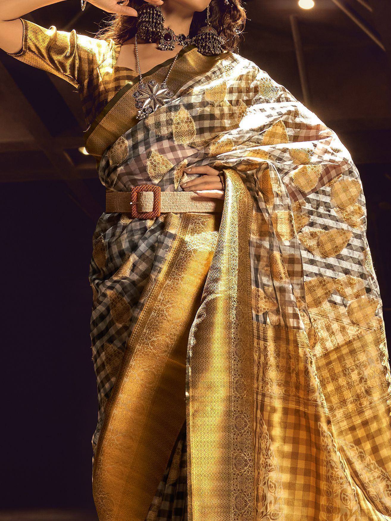 Golden checkered saree with embroidered motifs, styled with belt and ethnic jewelry for festive occasions