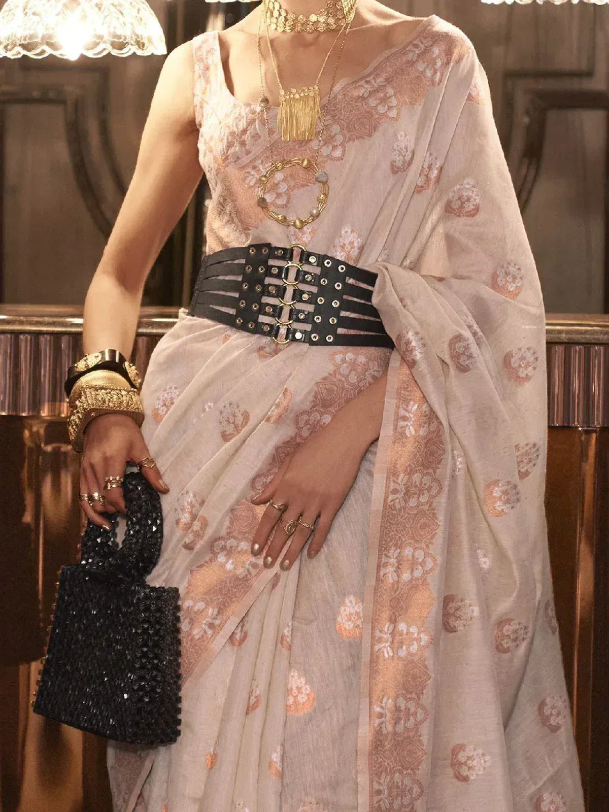 Elegant floral saree with gold embroidery, black belt, and statement jewelry for ethnic wear