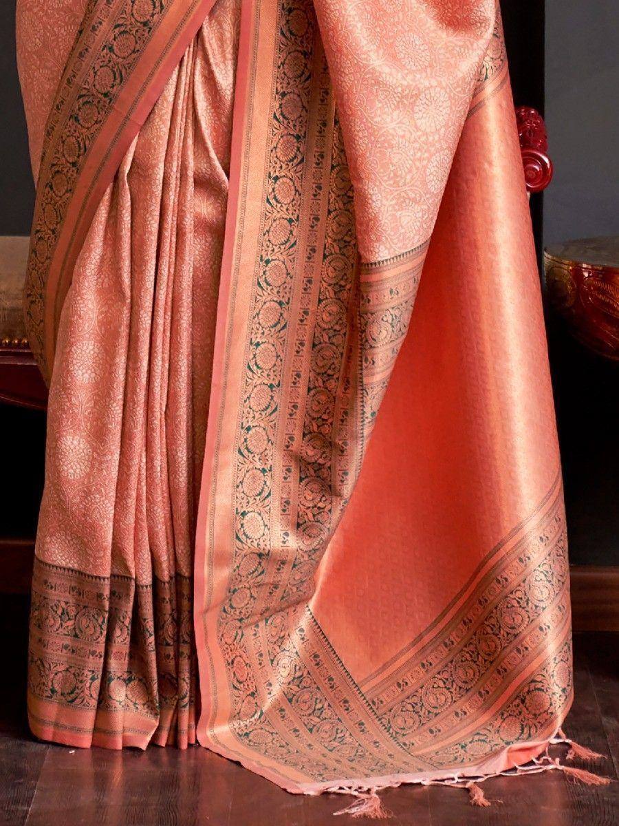 Peach silk saree with intricate gold and green brocade border, perfect for Indian ethnic wear occasions