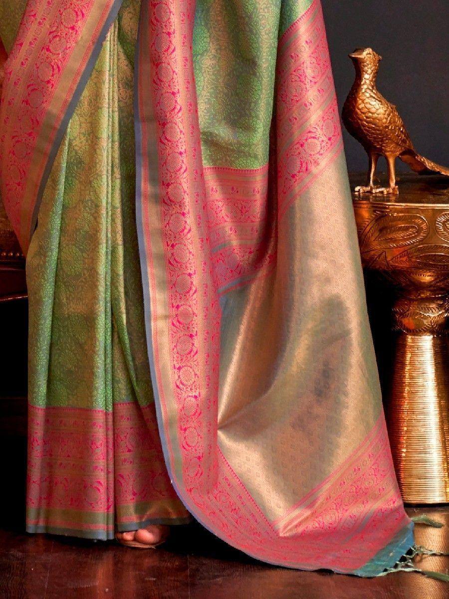 Green and pink designer saree with intricate gold zari border, perfect for ethnic wear occasions.