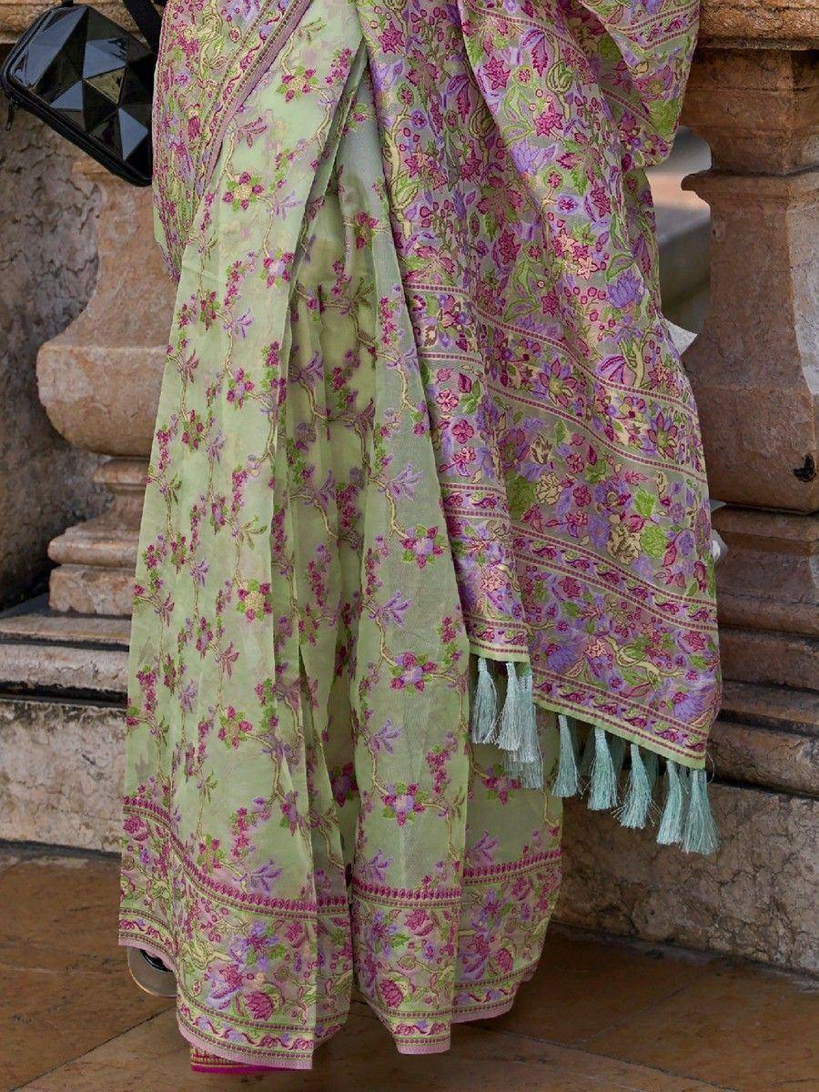 Light green floral saree with pink and purple embroidery, tassels, and border detail for ethnic wear