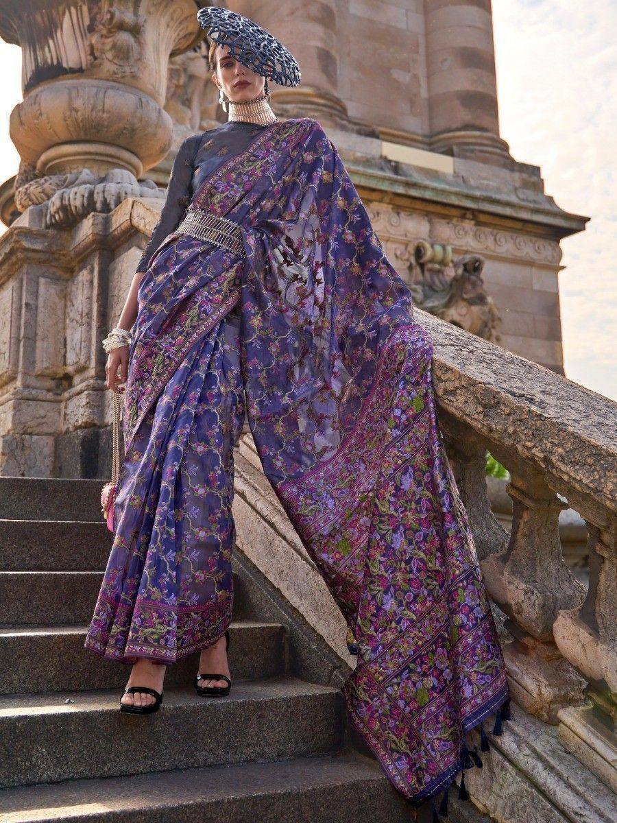 Purple floral saree with intricate embroidery, paired with a stylish hat, perfect for ethnic occasions.