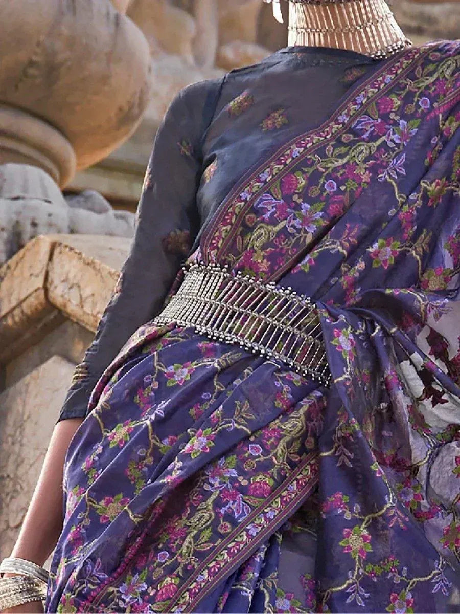 Elegant purple floral saree with intricate embroidery and beaded belt, perfect for ethnic occasions.