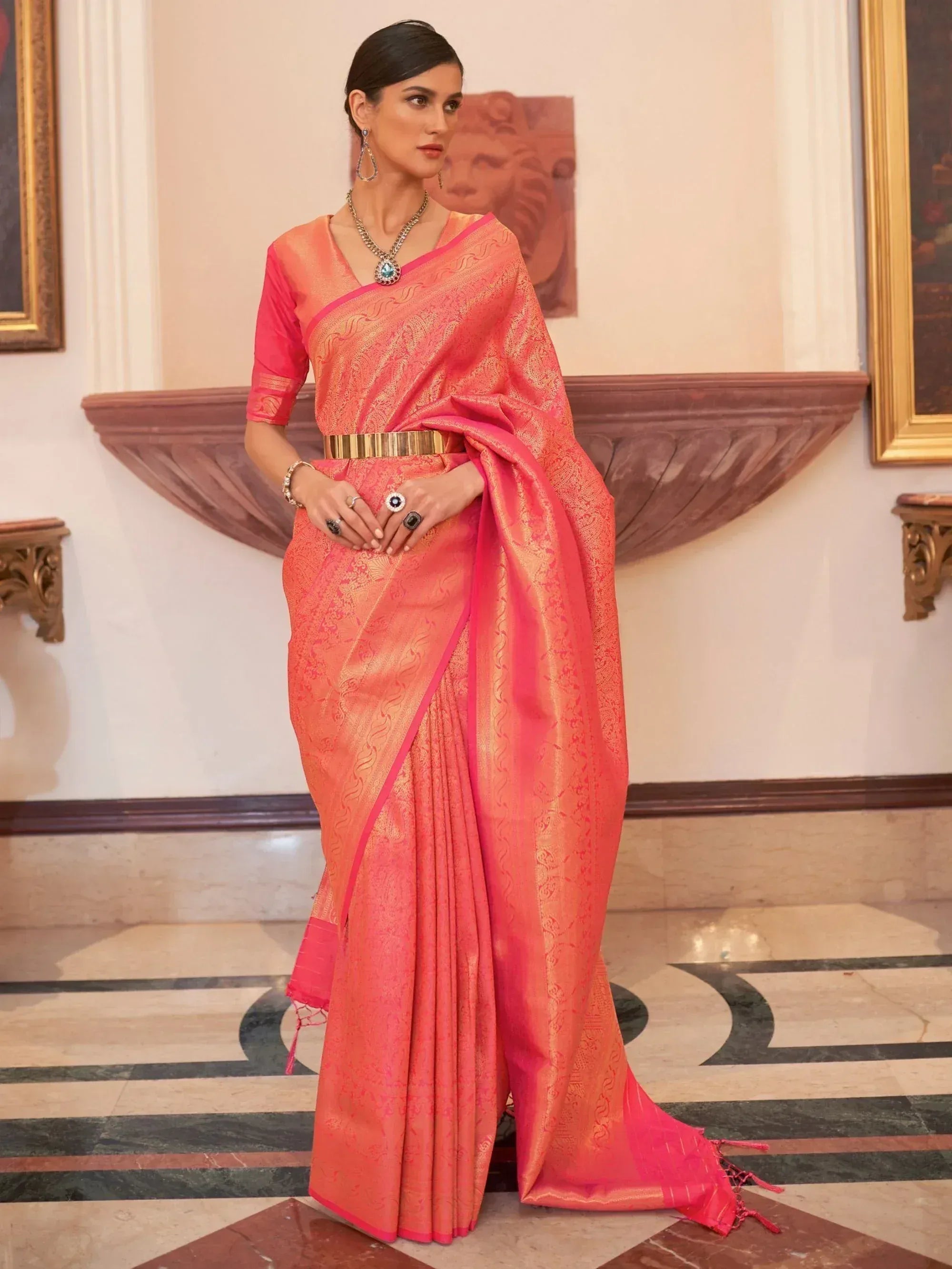 Elegant coral pink saree with gold zari work, perfect for Indian ethnic occasions and weddings