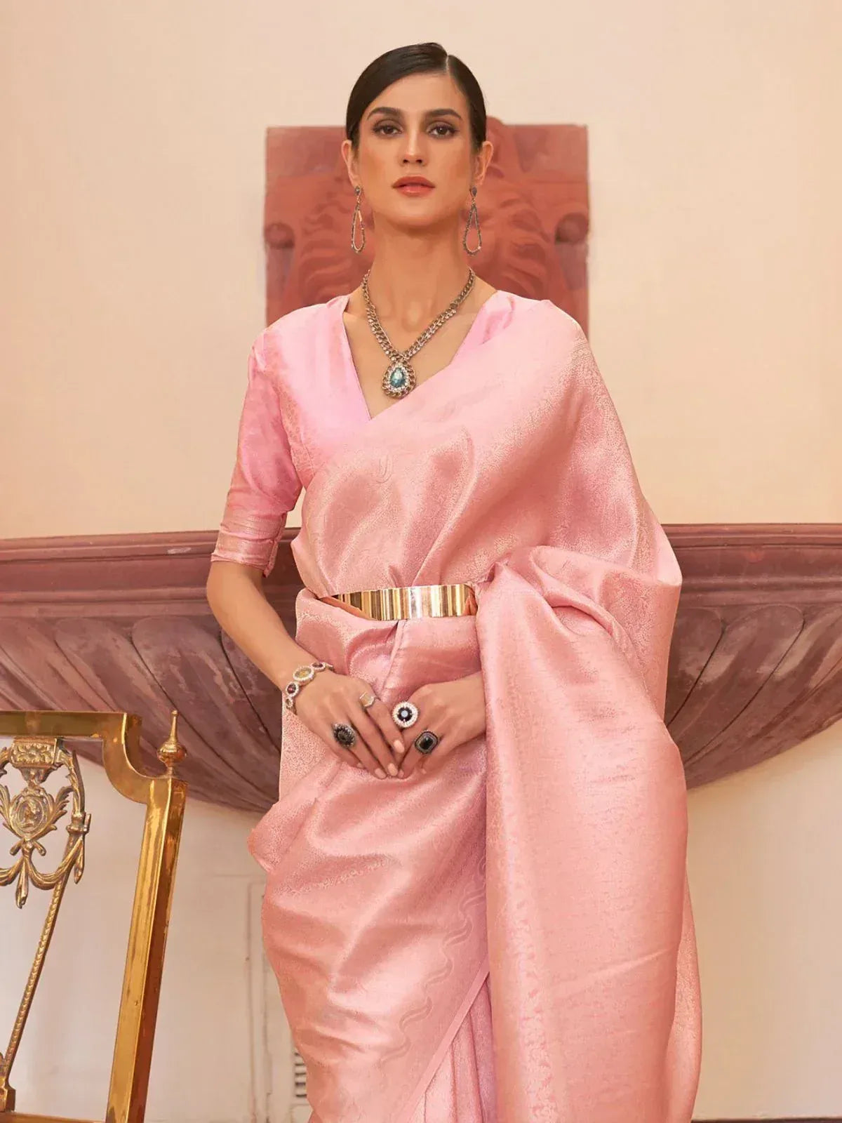 Elegant pink silk saree with gold belt, perfect for Indian ethnic wear and festive occasions.