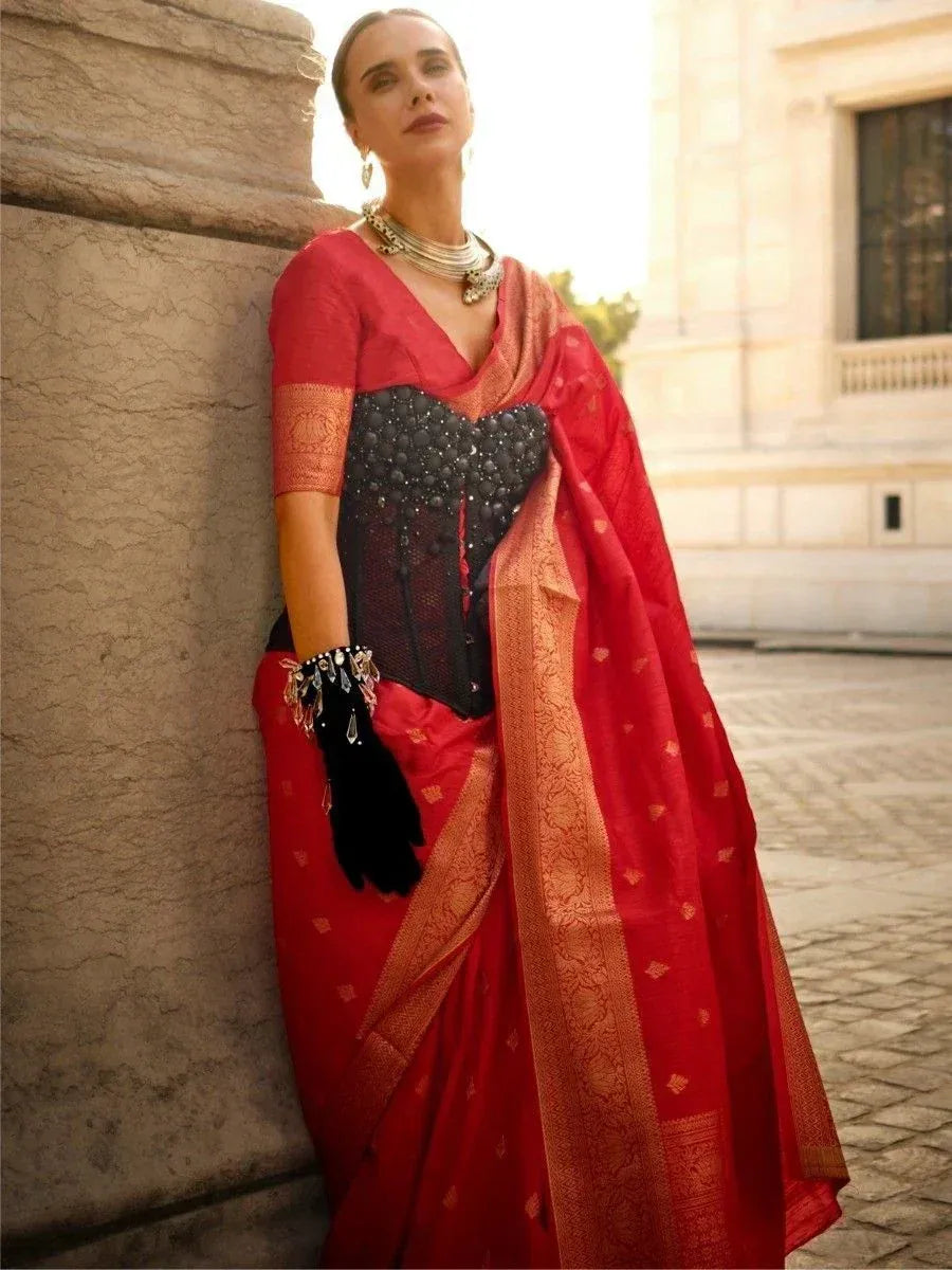 Red ethnic saree with black embellished blouse, gold border, and statement jewelry for festive occasions