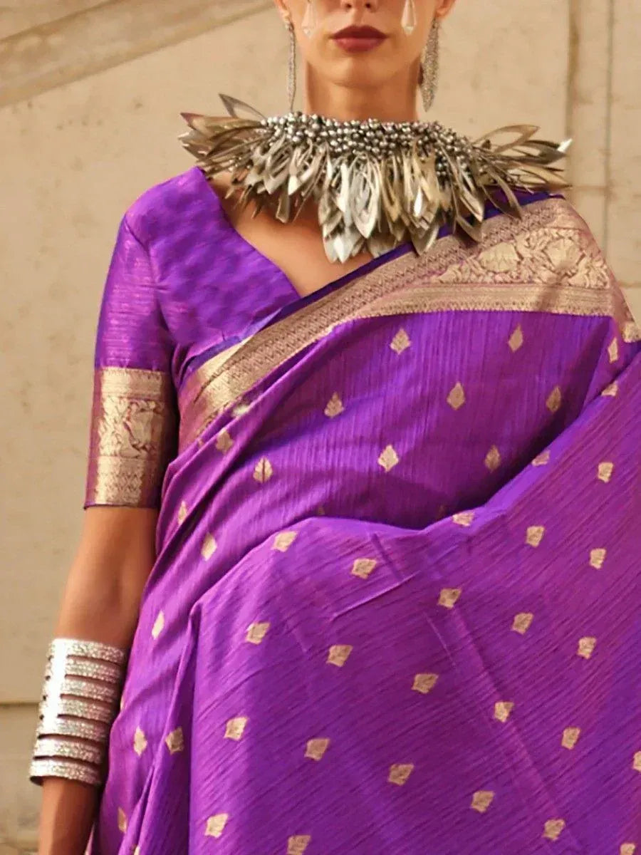 Purple ethnic saree with gold motifs and designer blouse, styled with statement jewelry for festive occasions