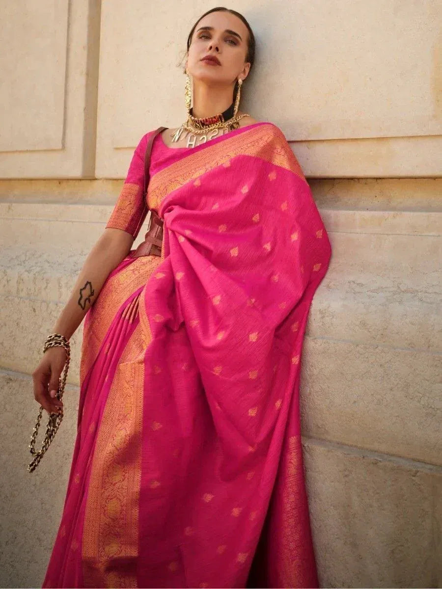 Vibrant pink ethnic saree with gold motifs, styled with statement jewelry for festive occasions