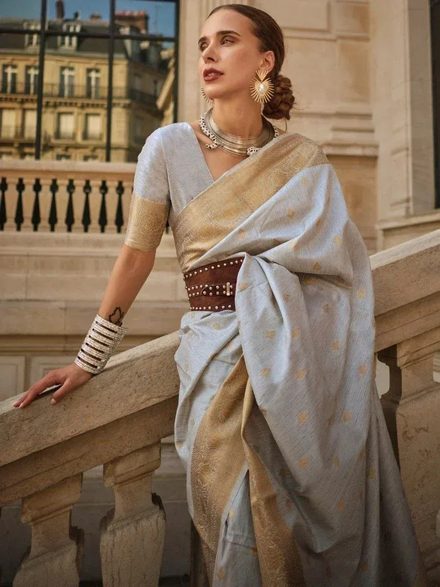 Elegant light blue and gold ethnic saree with statement jewelry, styled for modern Indian fashion