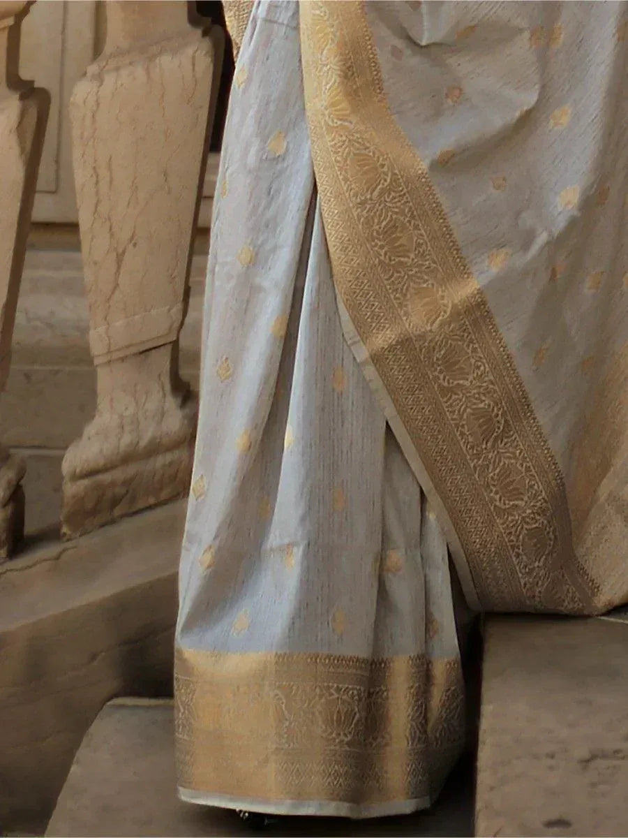 Elegant light blue saree with gold zari border and floral motifs, perfect for ethnic occasions.