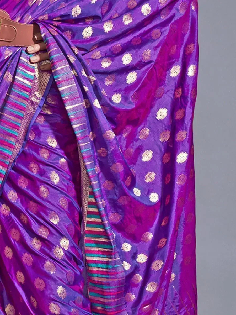 Purple ethnic saree with gold floral motifs and colorful striped border, styled with belt