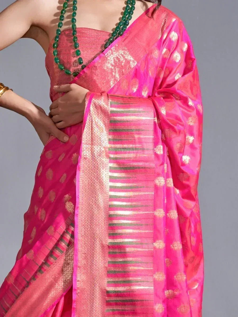 Pink designer saree with gold motifs and striped border, paired with green beads