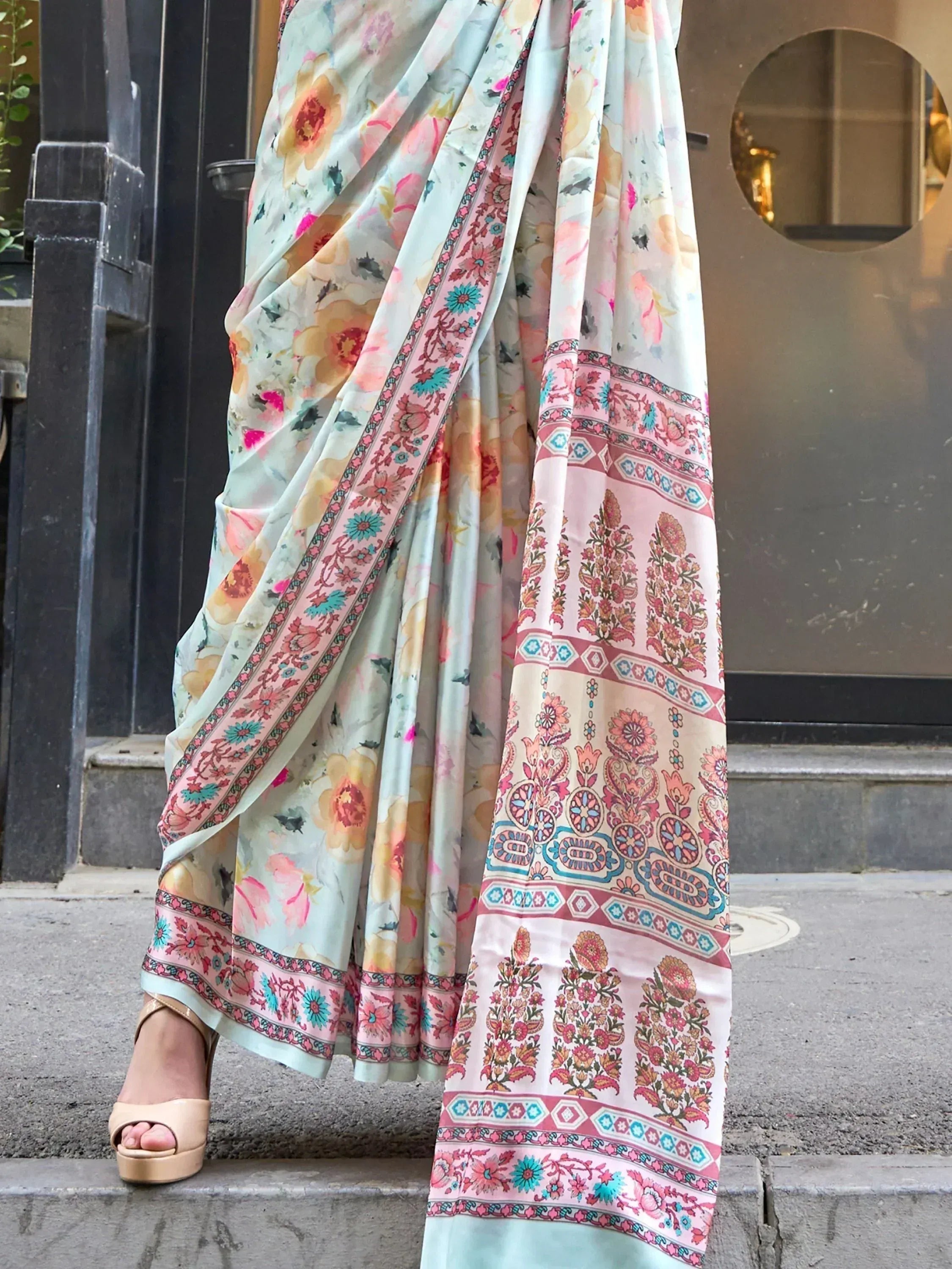 Floral print saree with pink and teal border, styled with heels for ethnic wear