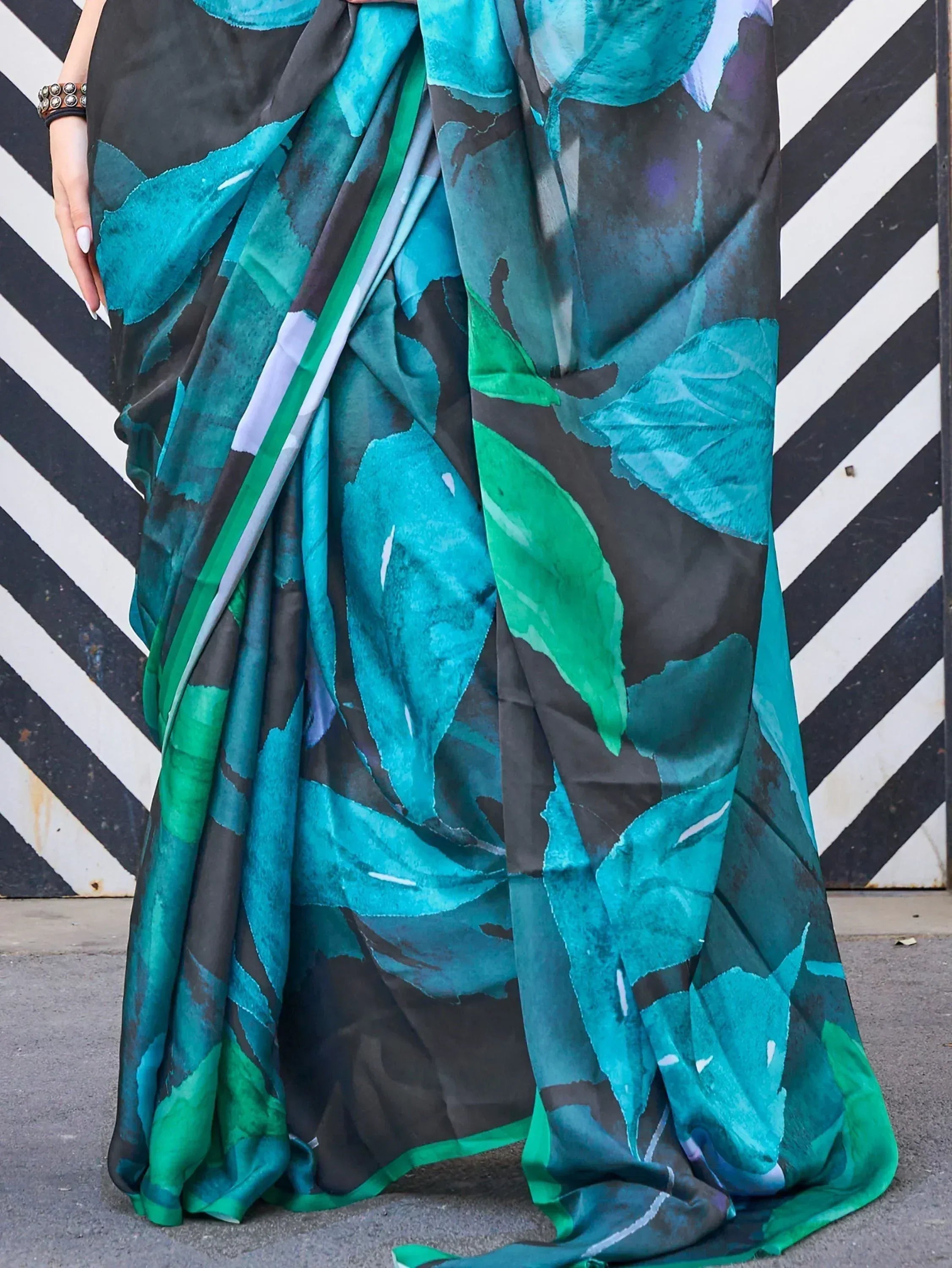Stylish printed saree with teal and green leaf pattern, perfect for ethnic wear occasions