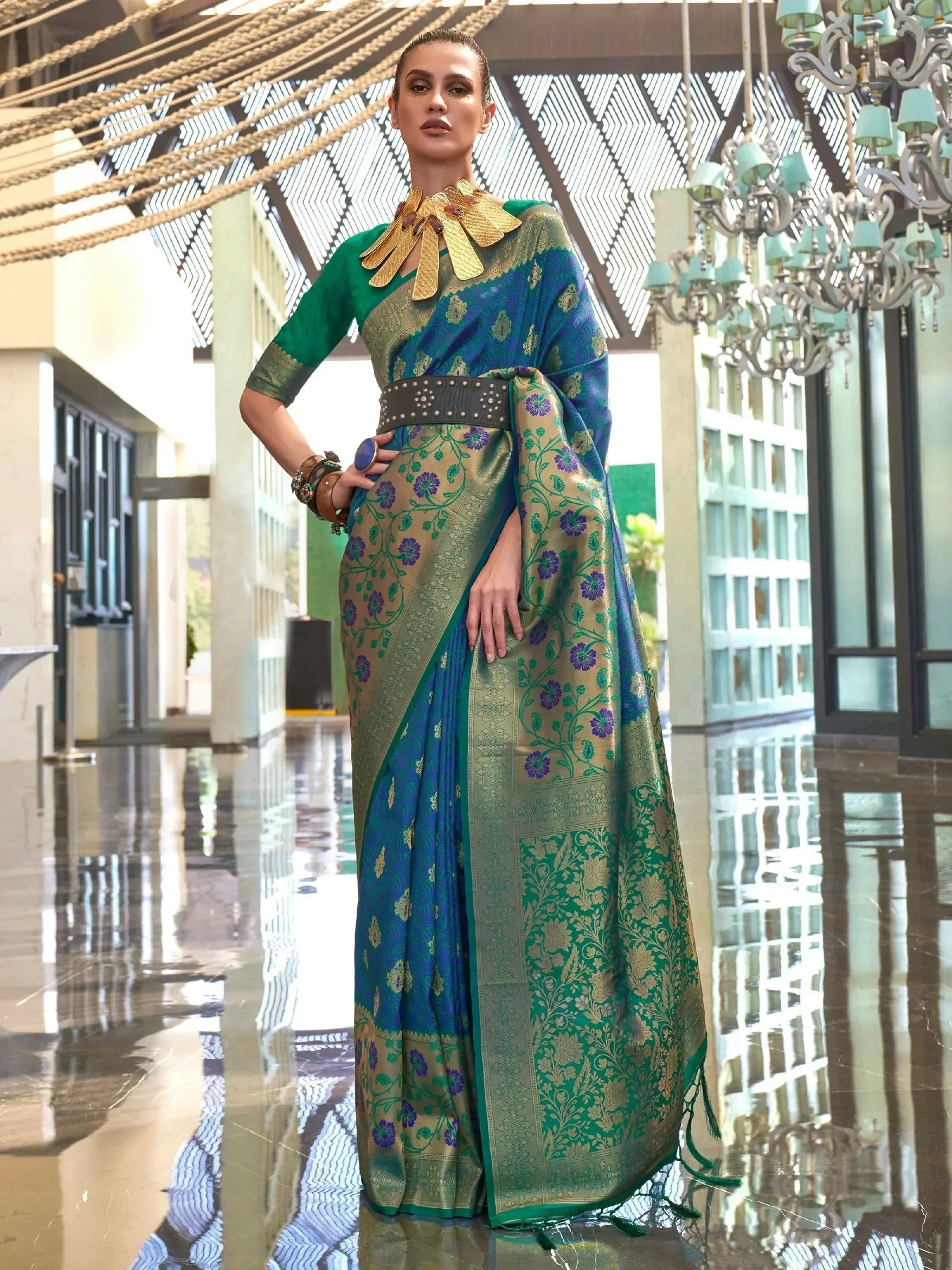 Elegant green and blue floral saree with gold zari work, styled with statement jewelry for Indian ethnic wear.