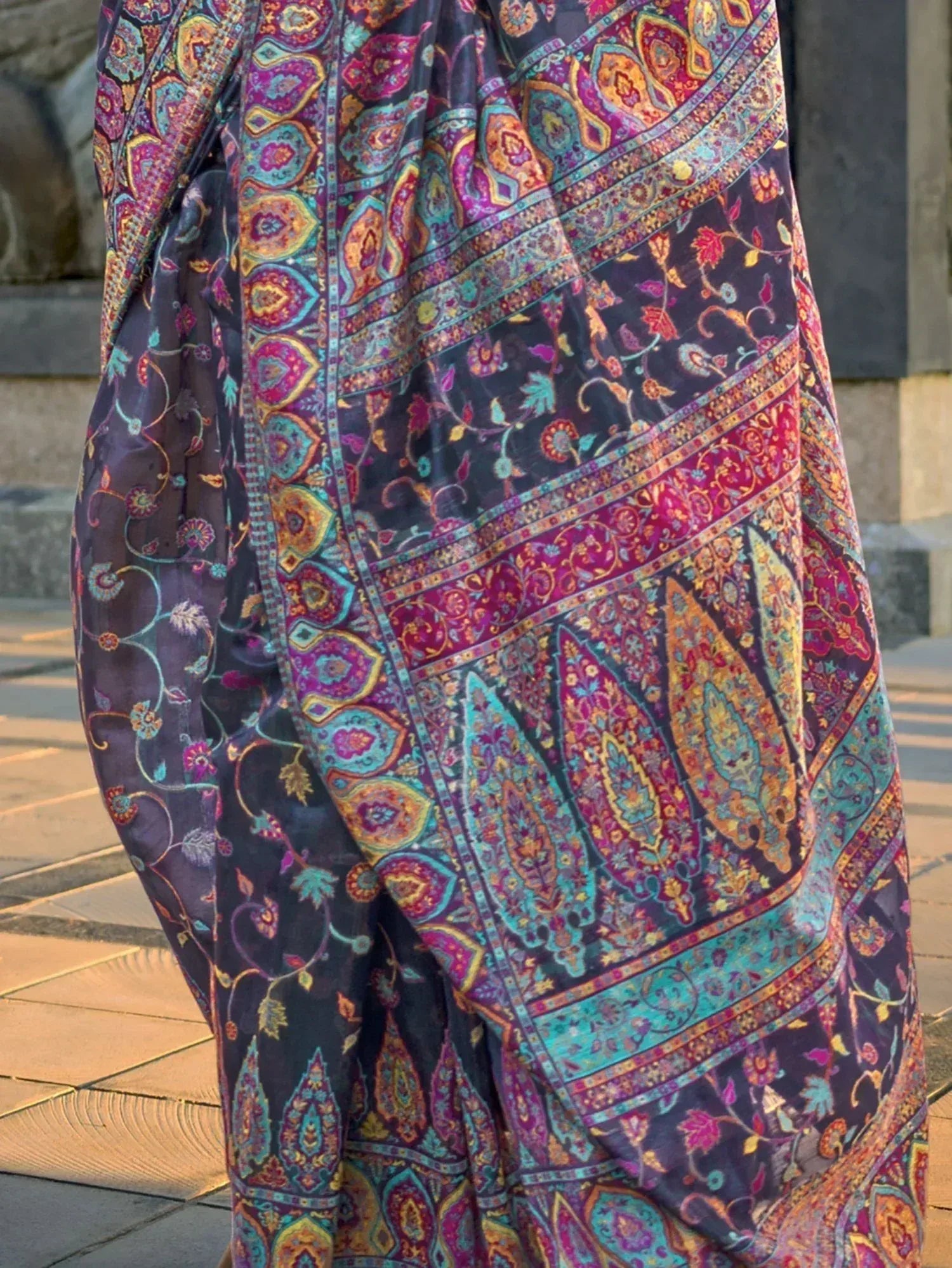 Vibrant paisley print ethnic gown with colorful floral patterns, perfect for Indian occasions.