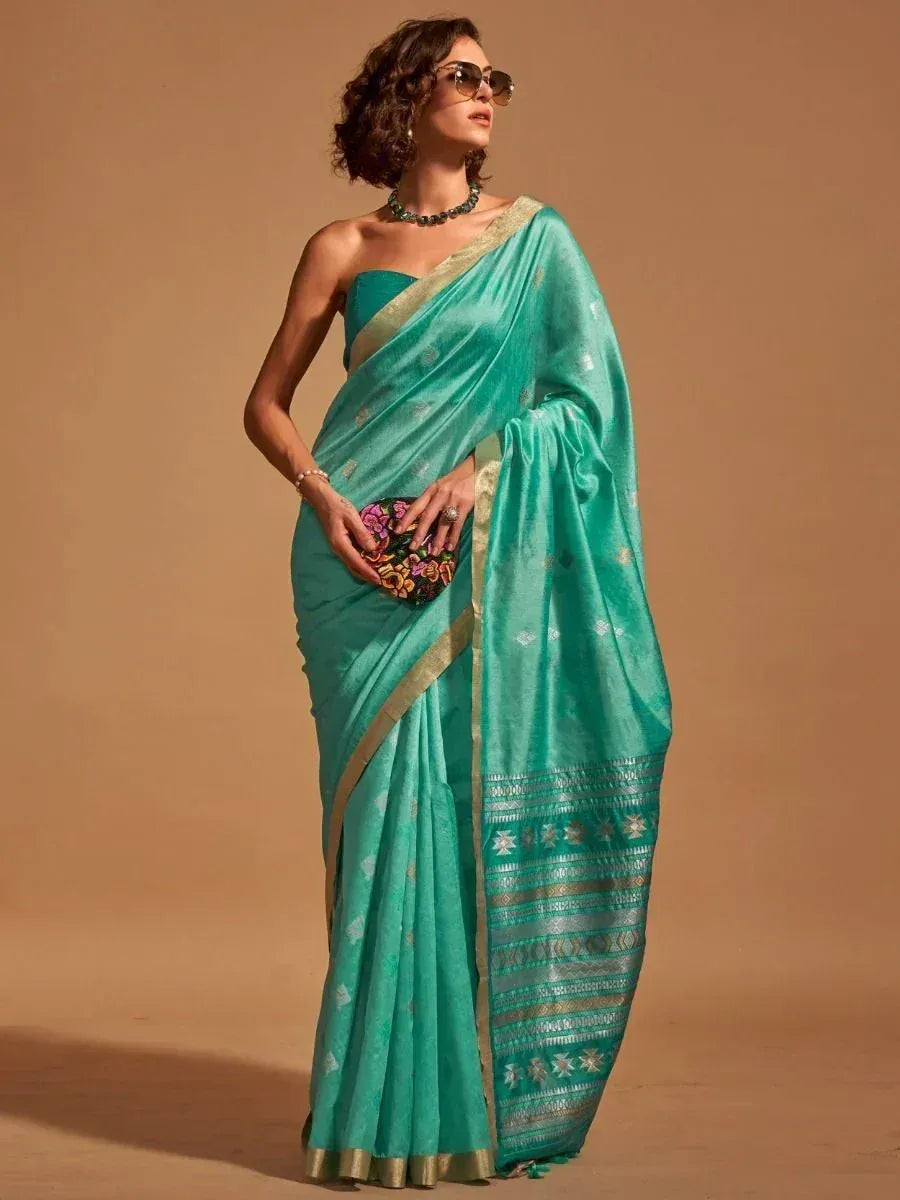 Teal saree with gold border and floral clutch, styled for ethnic wear
