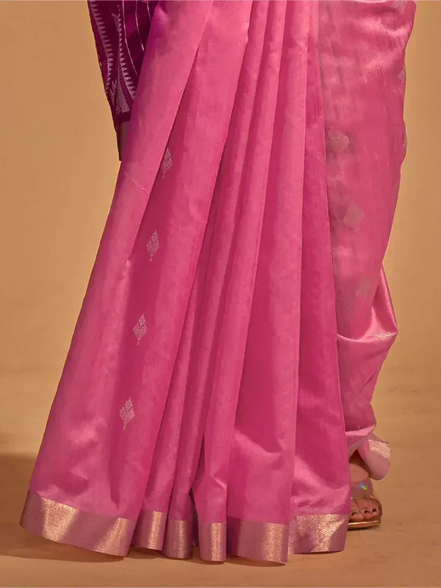 Pink silk saree with gold border and subtle woven motifs, paired with purple blouse