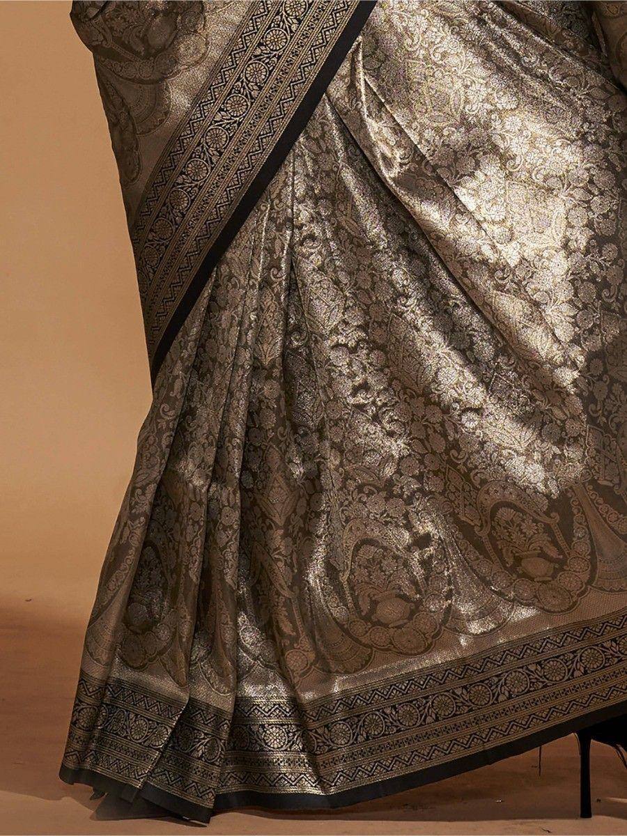 Elegant gold and black designer saree with intricate paisley and floral brocade patterns, perfect for ethnic occasions.