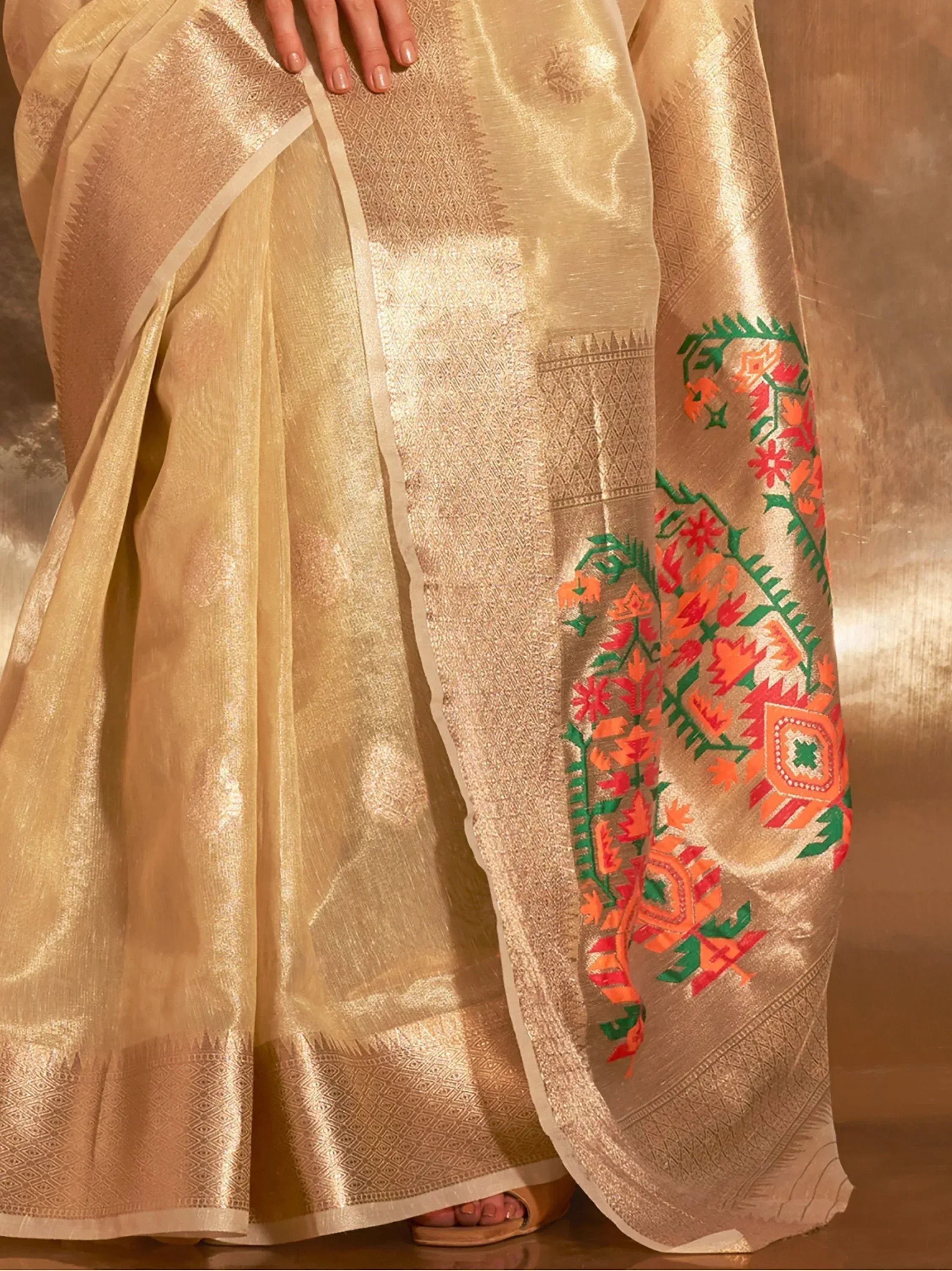 Golden saree with vibrant floral embroidery and woven border, perfect for ethnic occasions