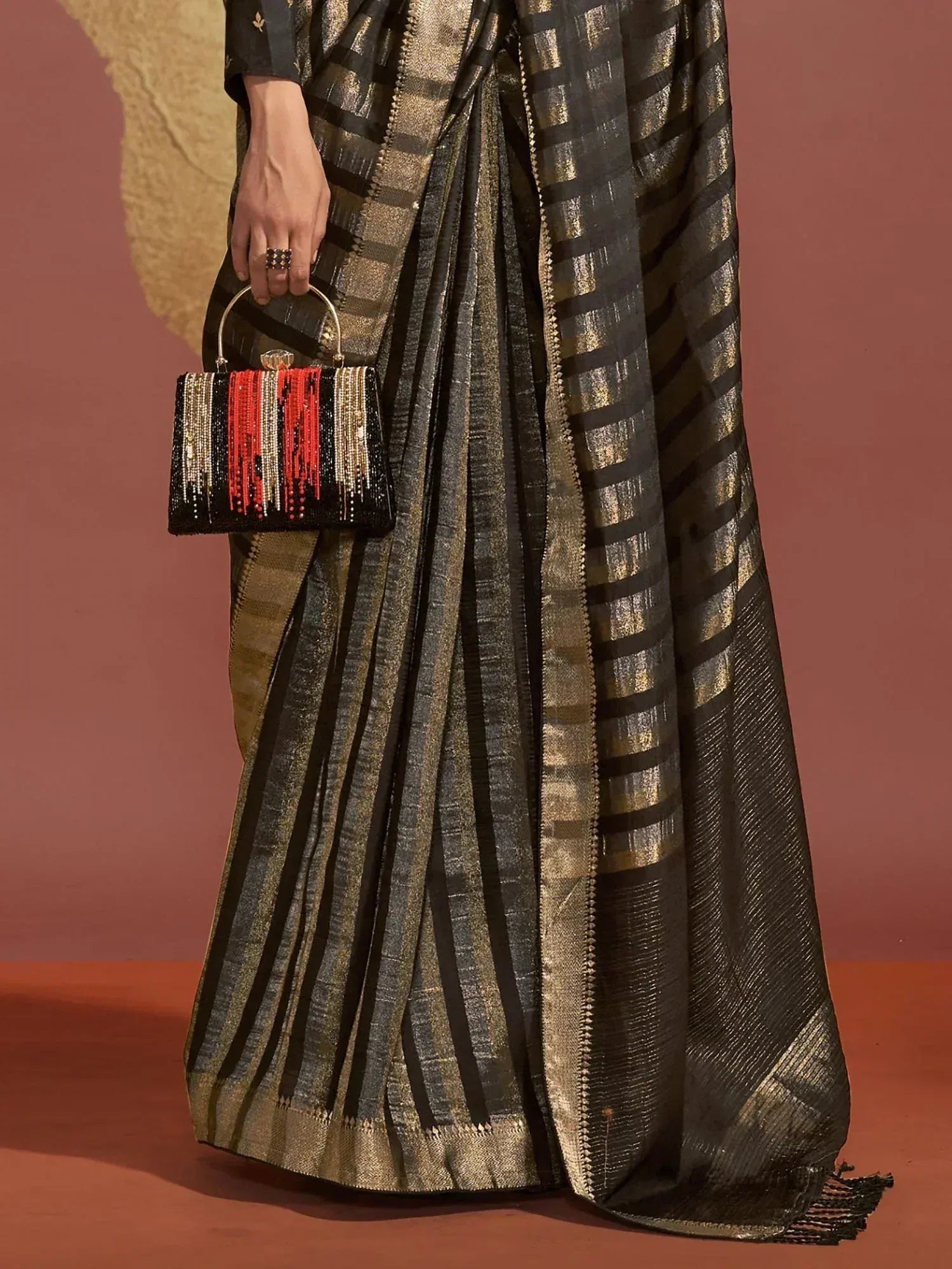 Black and gold striped saree with beaded clutch, Indian ethnic wear