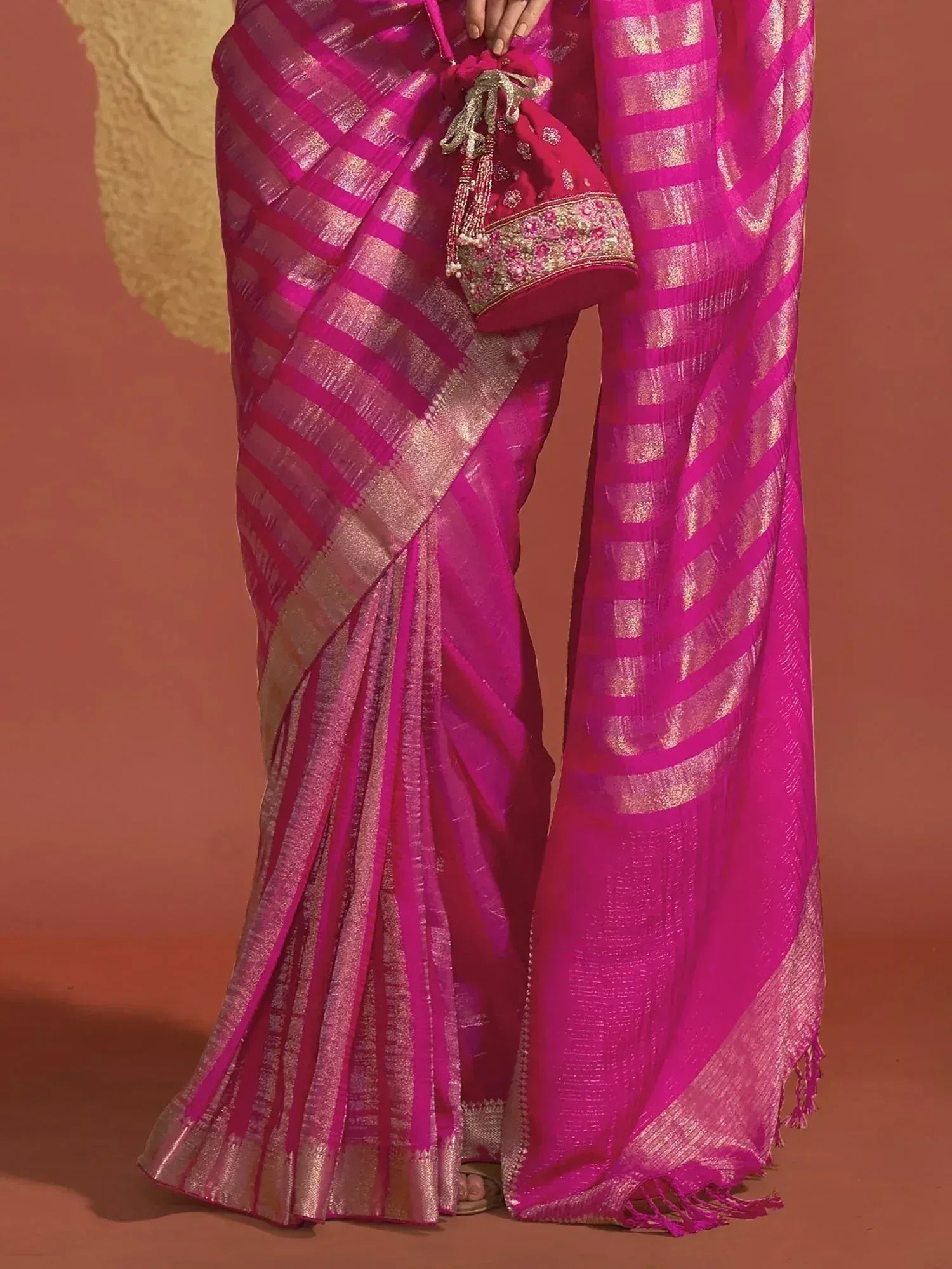 Pink and gold striped saree with embroidered potli bag, Indian ethnic wear