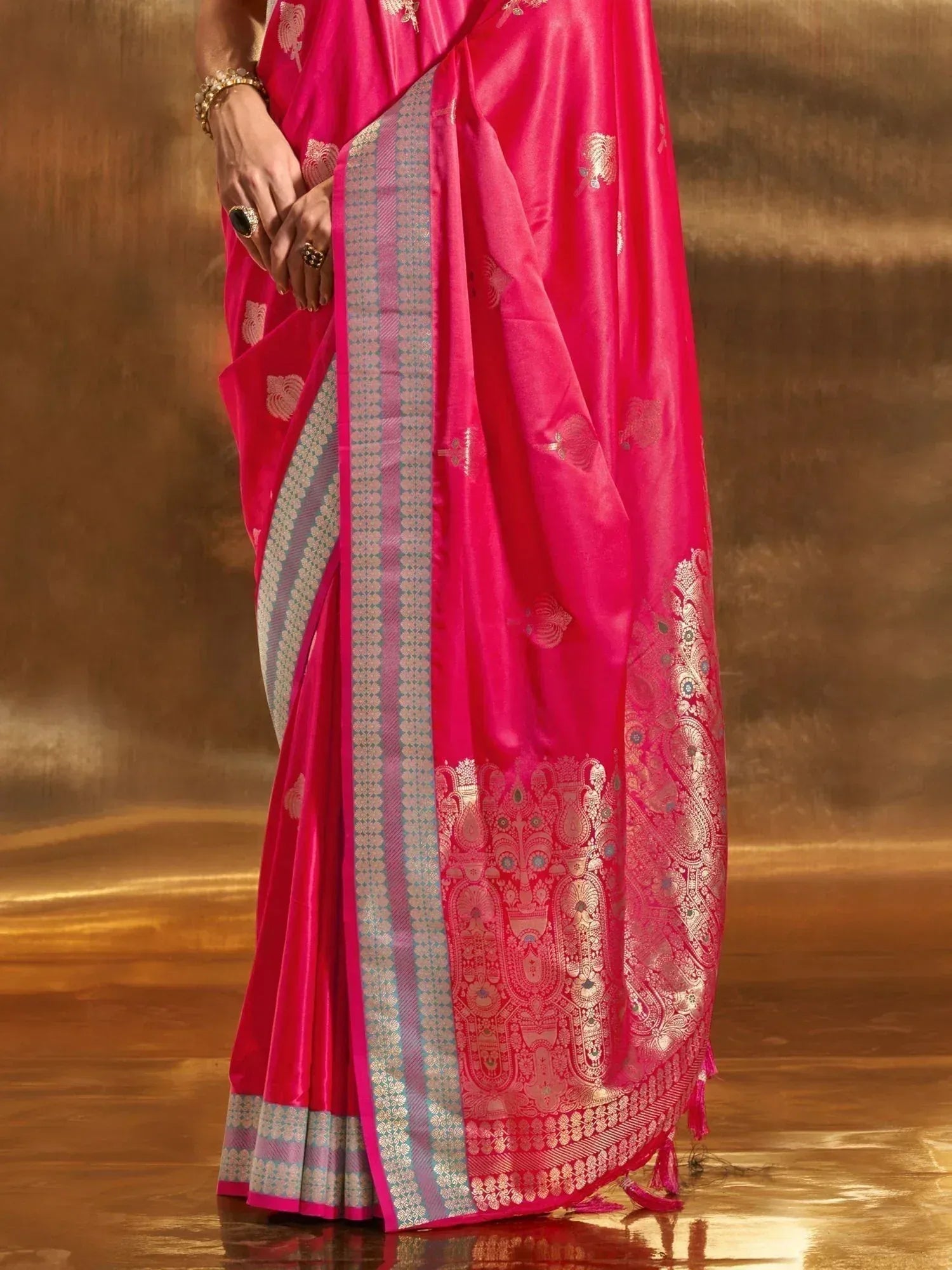 Vibrant pink silk saree with gold paisley motifs and intricate border, perfect for Indian ethnic occasions