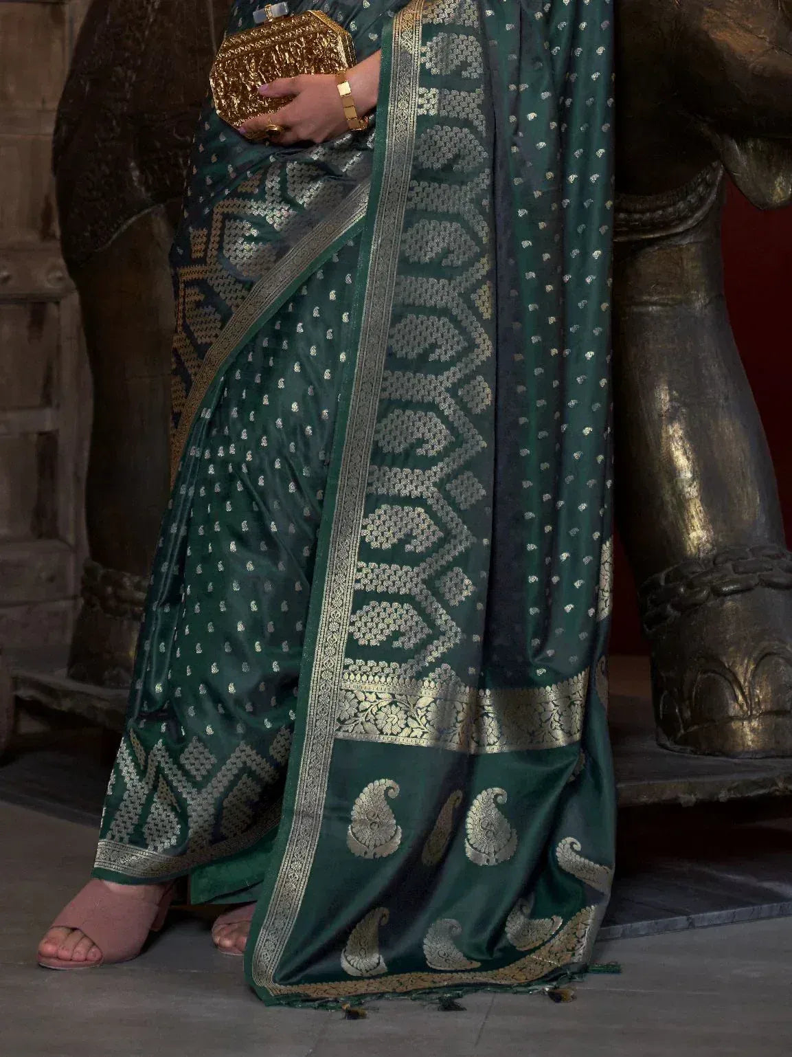 Emerald green designer saree with gold paisley and geometric zari work, perfect for ethnic occasions