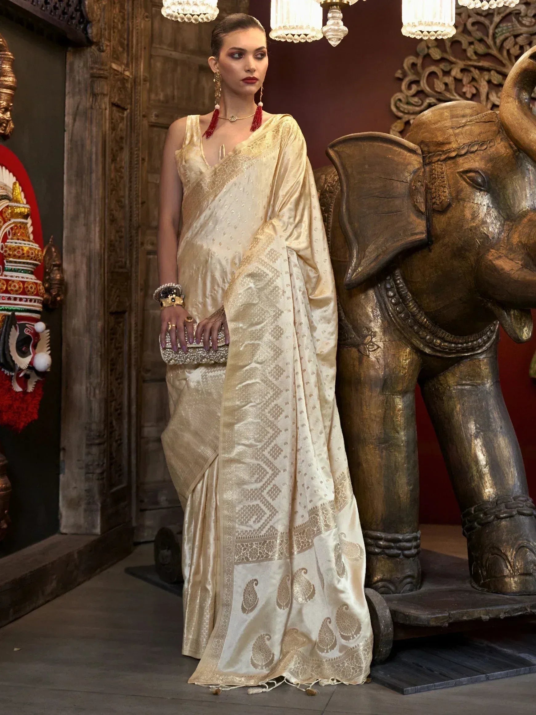 Elegant cream saree with gold paisley print, perfect for Indian ethnic wear and festive occasions.