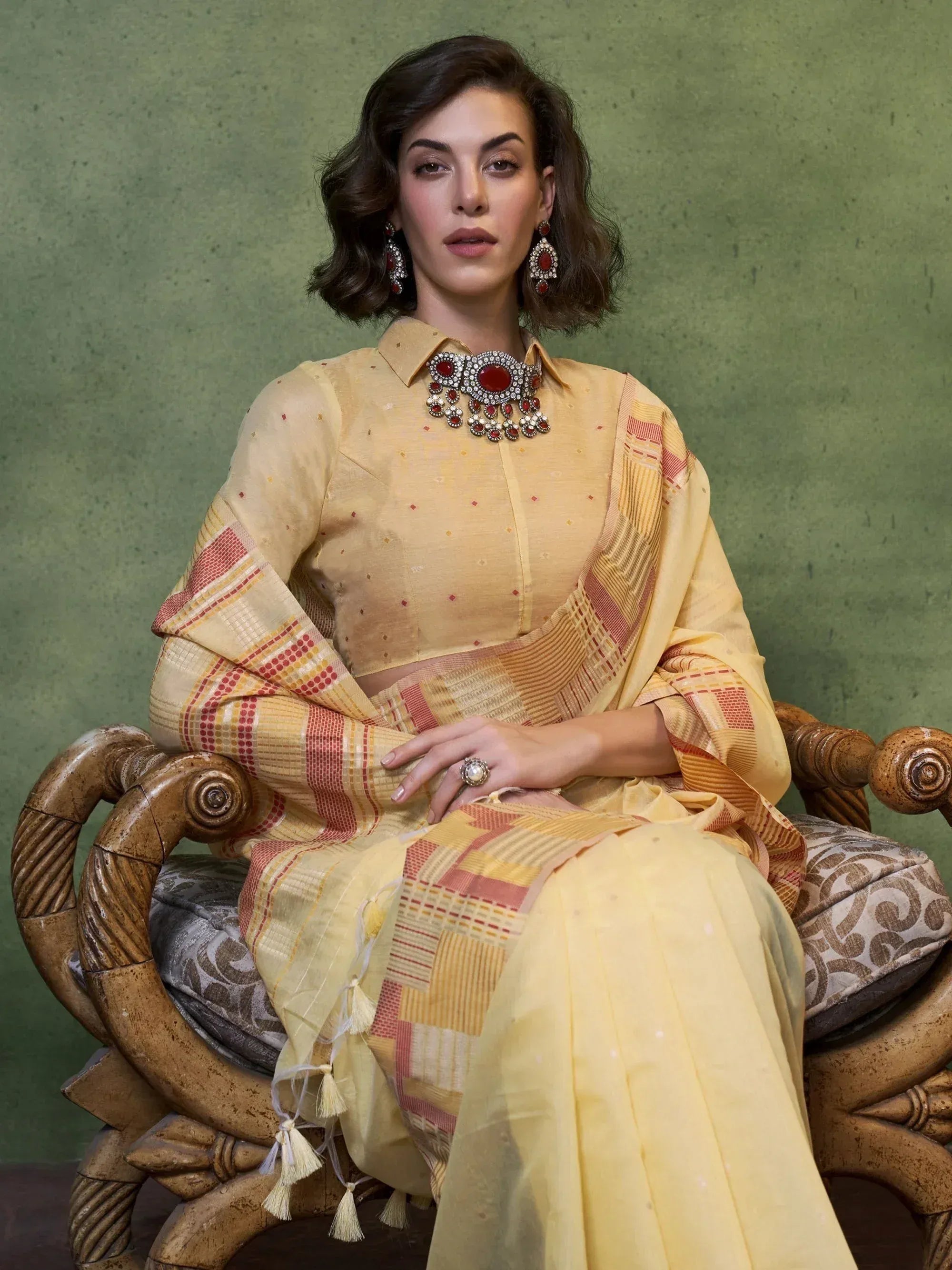 Yellow ethnic salwar kameez with red patterned dupatta, styled with statement jewelry for festive occasions