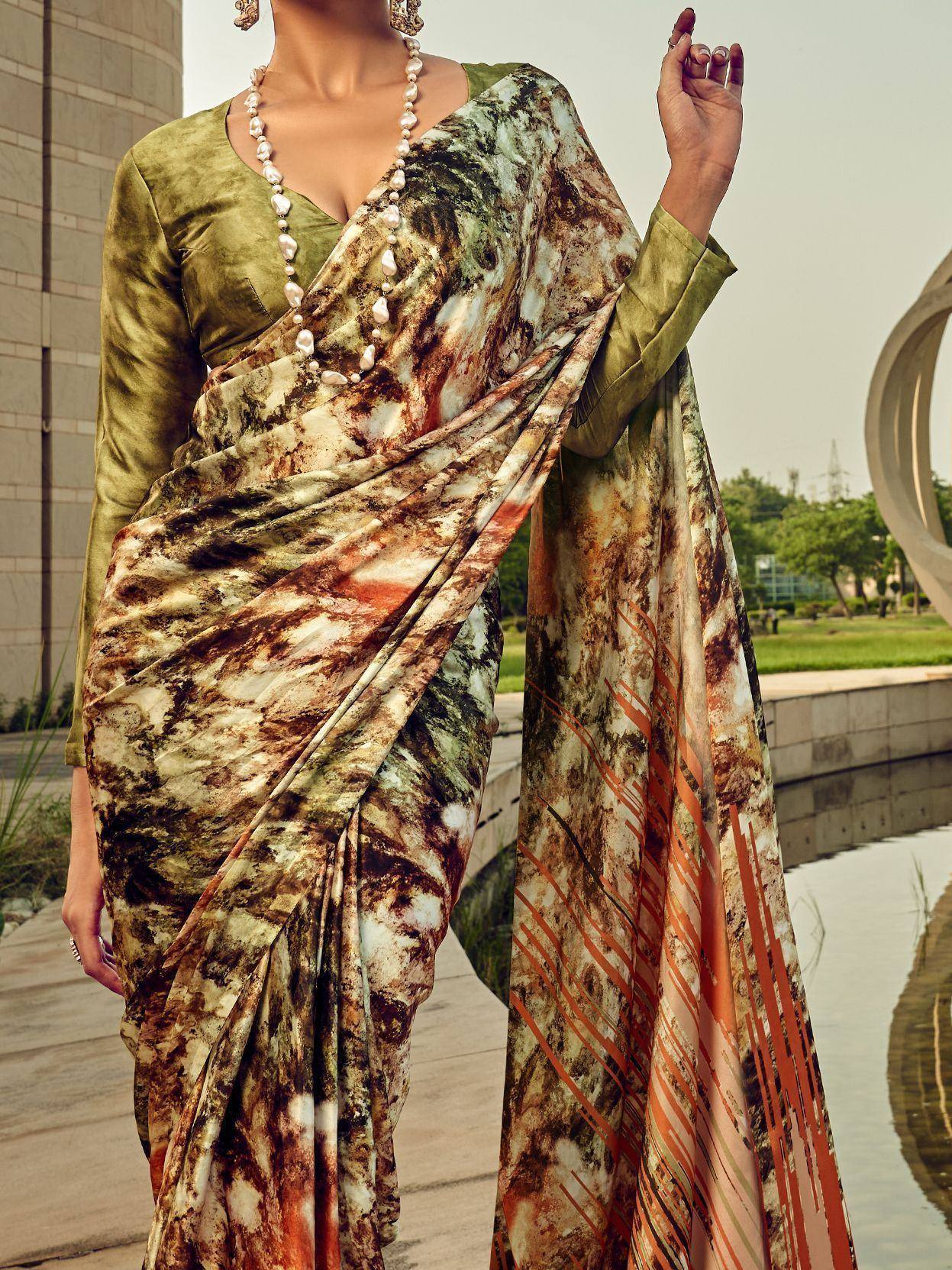 Woman in olive green designer saree with abstract print, styled with pearl necklace for ethnic wear