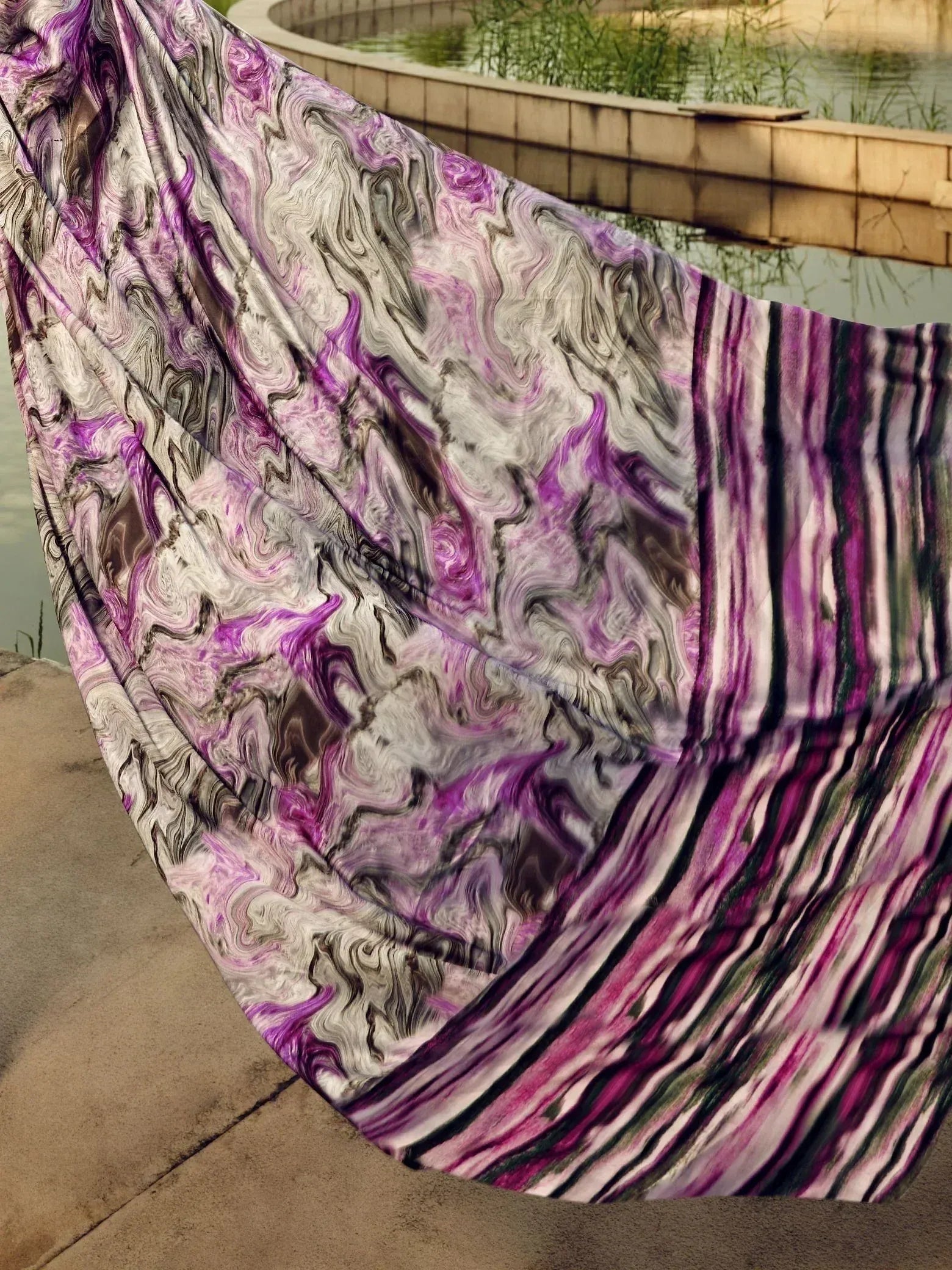 Purple and white abstract printed ethnic saree with marble and striped pattern near water