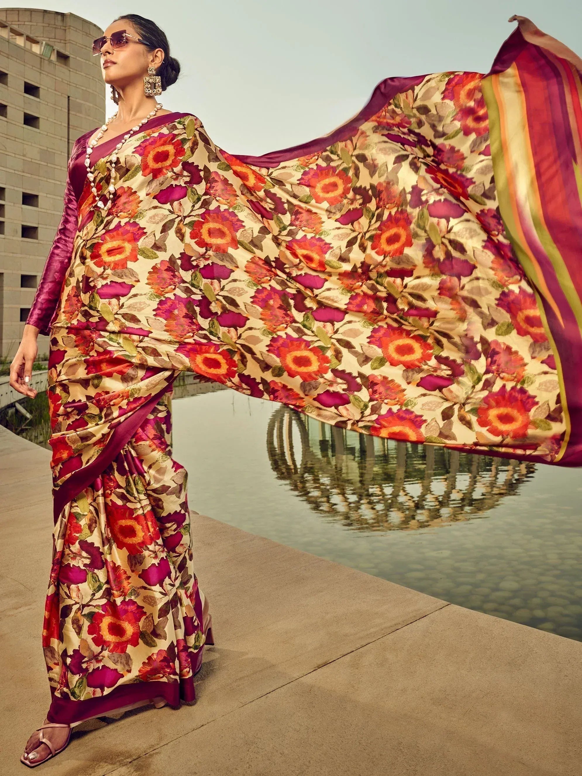 Woman in vibrant floral saree with purple blouse, stylish ethnic wear for festive occasions