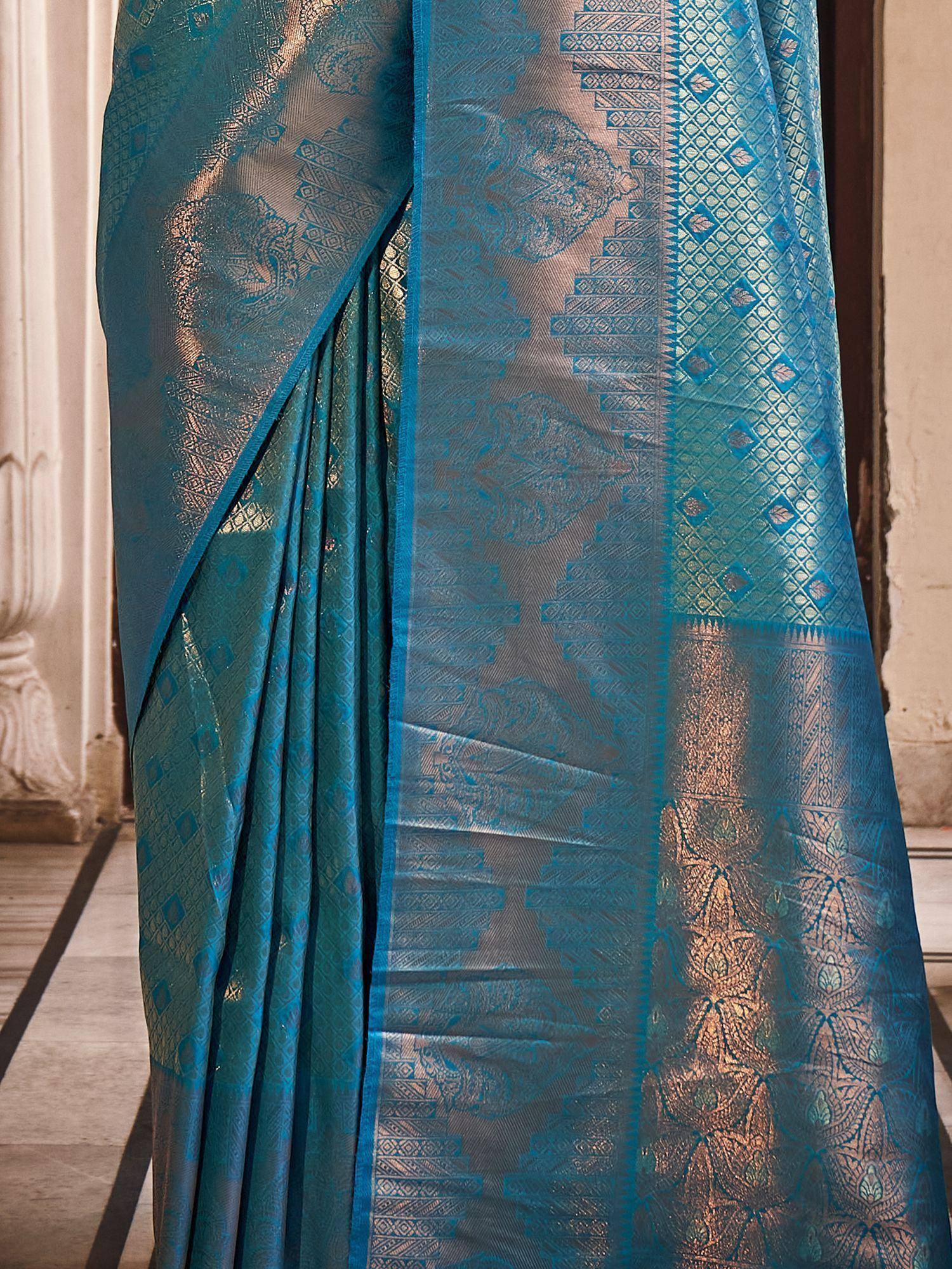 Teal blue designer saree with intricate gold zari work and geometric patterns, perfect for ethnic occasions
