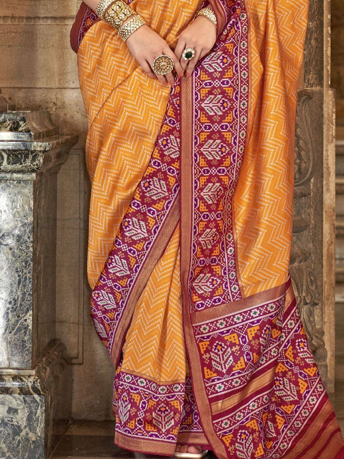 Vibrant orange and maroon ethnic saree with geometric patterns, perfect for Indian celebrations